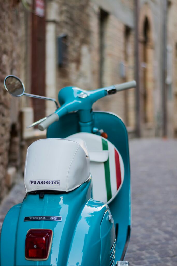 a Vespa parked in the street
