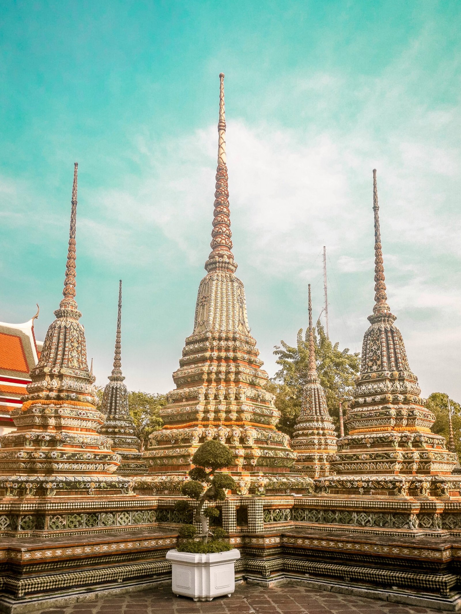 Ornate colorful stupas at Wat Pho temple in Bangkok, Thailand, showcasing traditional Thai architecture for a spiritual wellness journey in 2026.