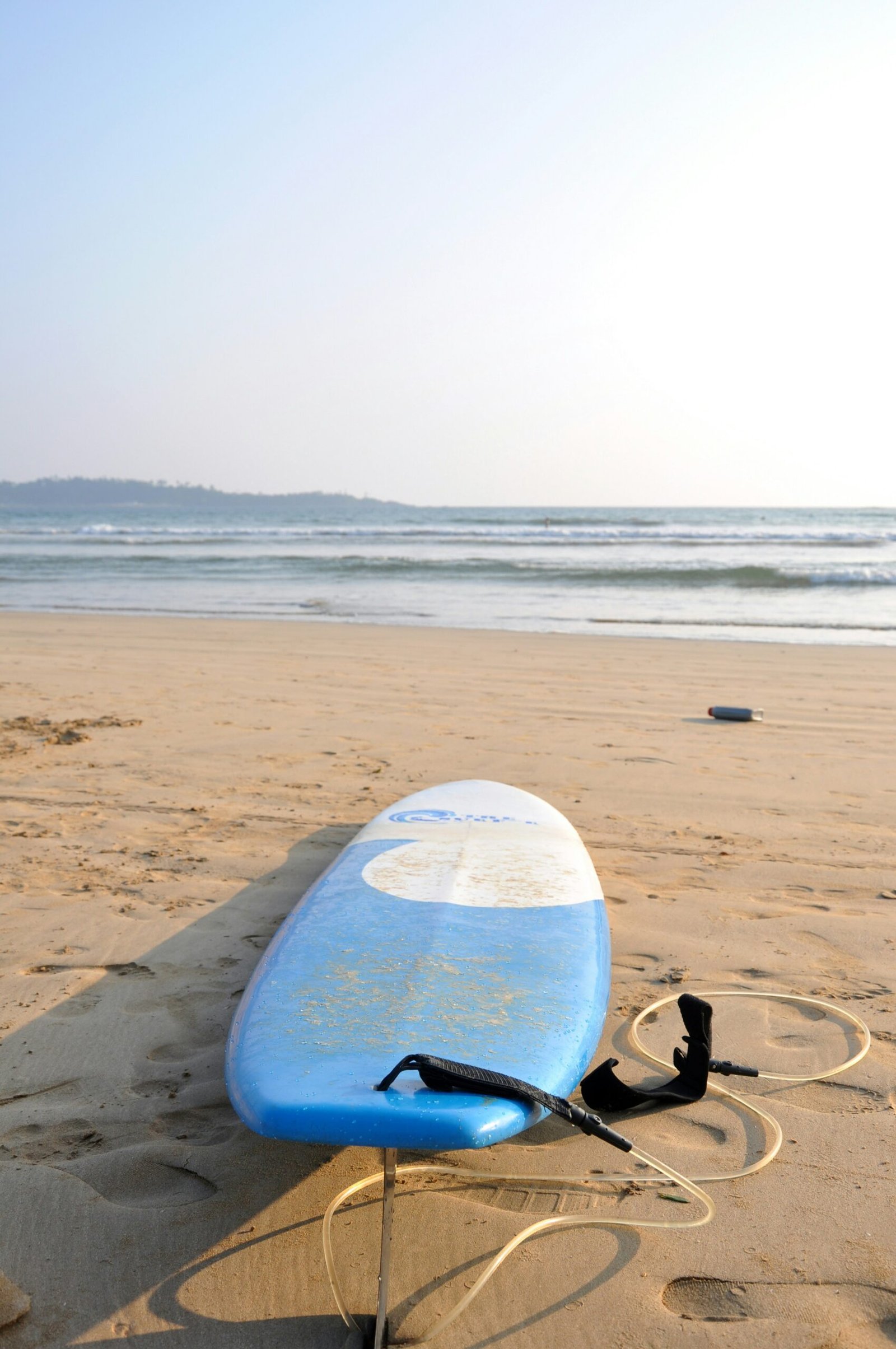 Surfboard resting on the shore in Weligama, Sri Lanka, suited to a retreat that blends yoga, movement, and ocean time.