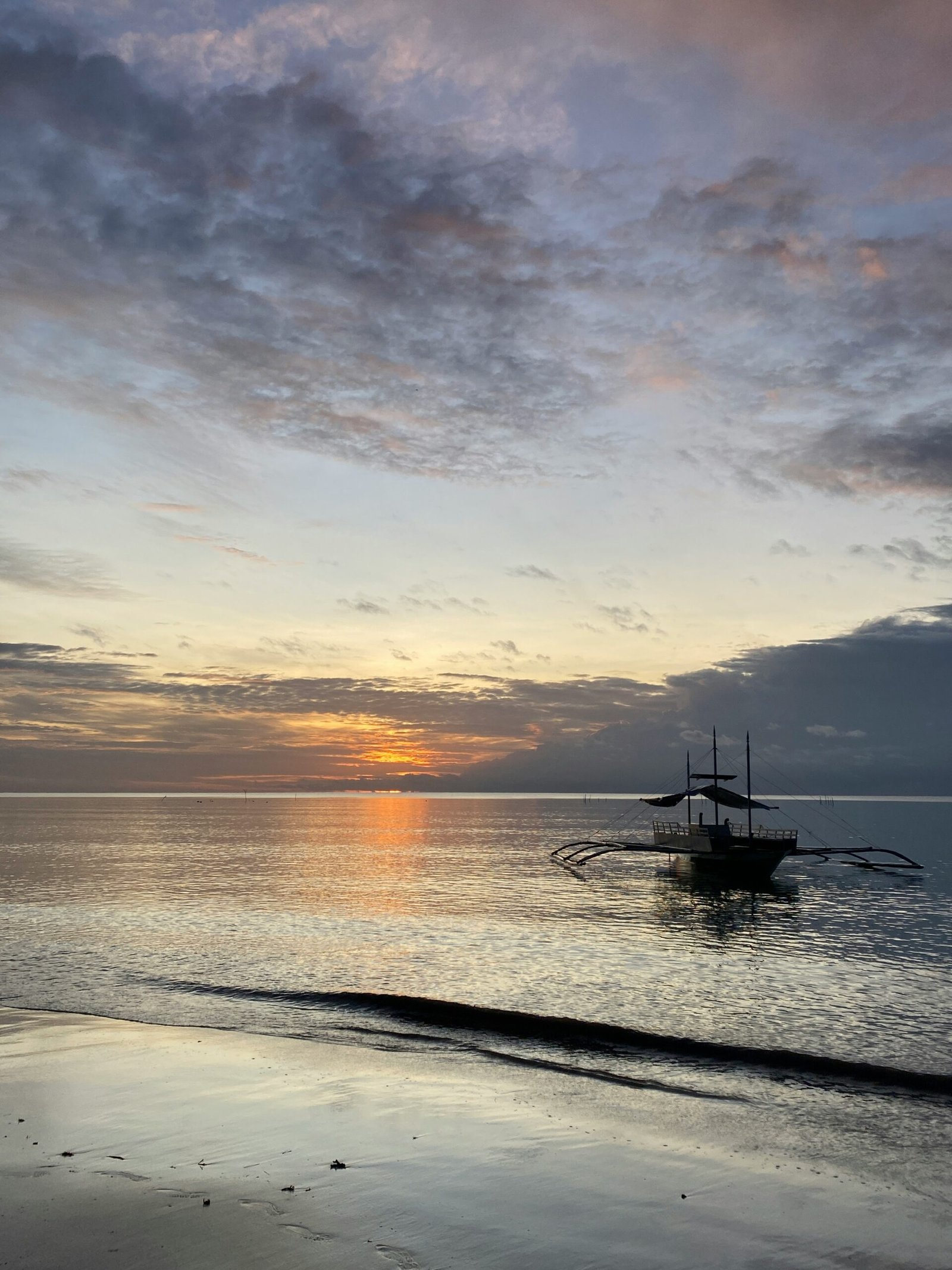 quiet fishing boat off amed beach at sunrise in bali’s winter season