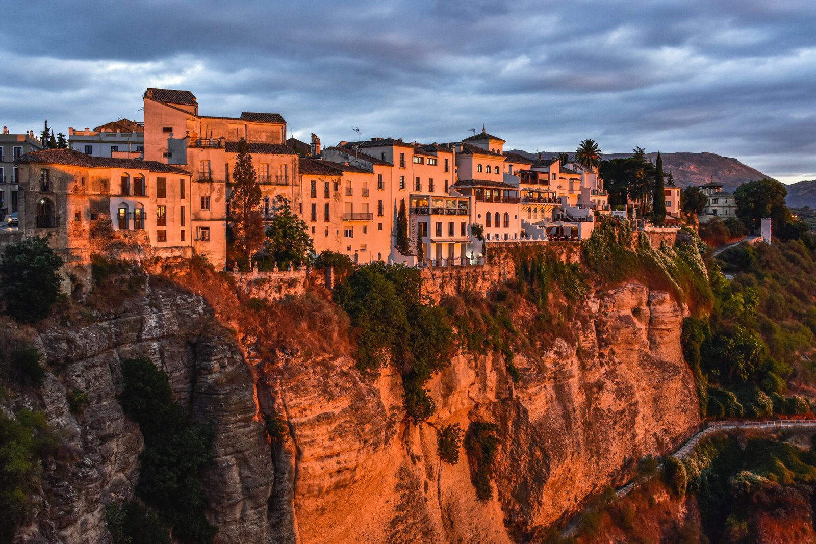 Cliffside town view in Ronda, Spain, overlooking the gorge in warm evening light.
