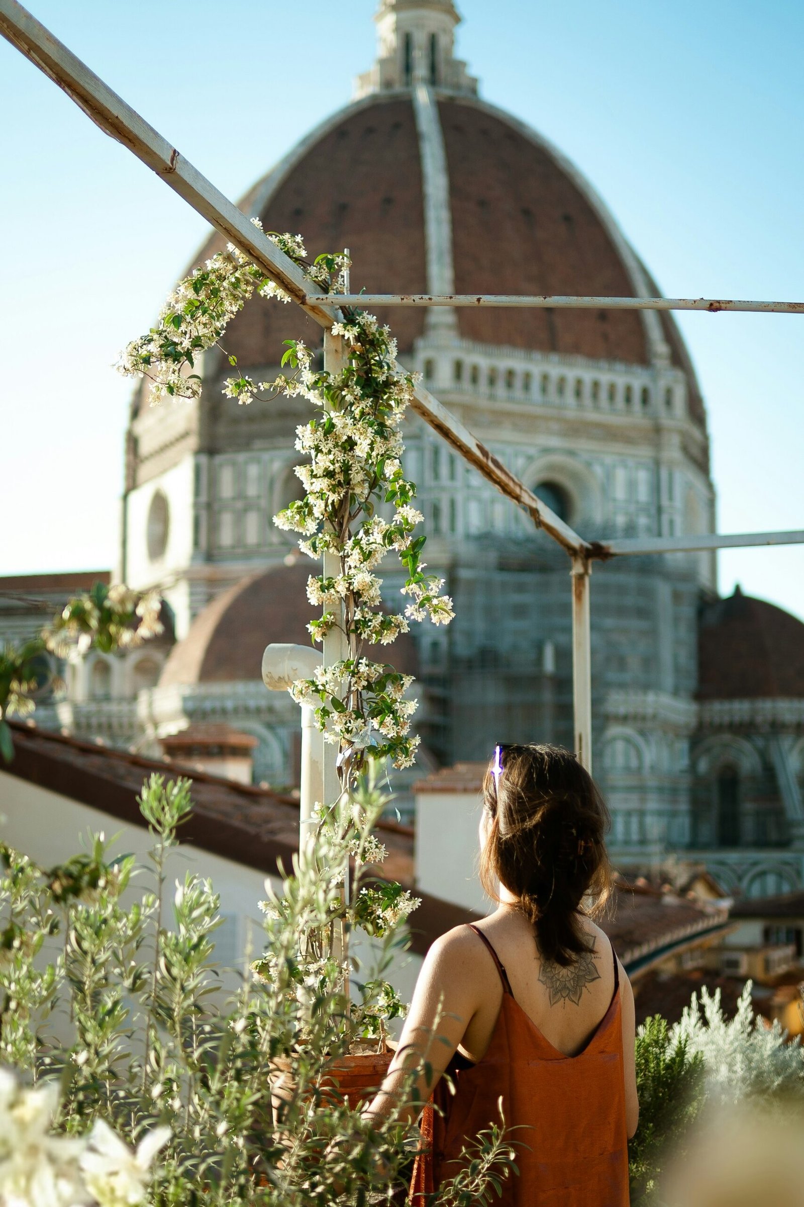 A person standing in front of large building in italy