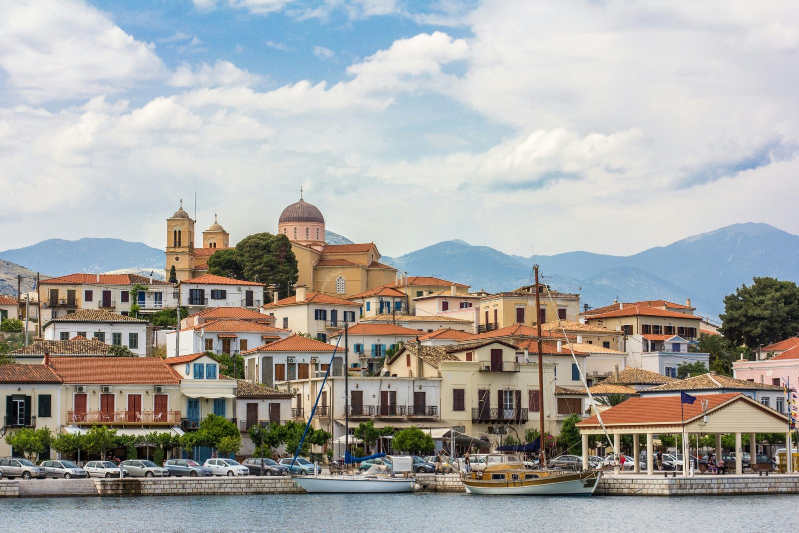 Pelion harbor and red-roofed seaside buildings in Greece, matching a slower autumn retreat on the mainland coast.