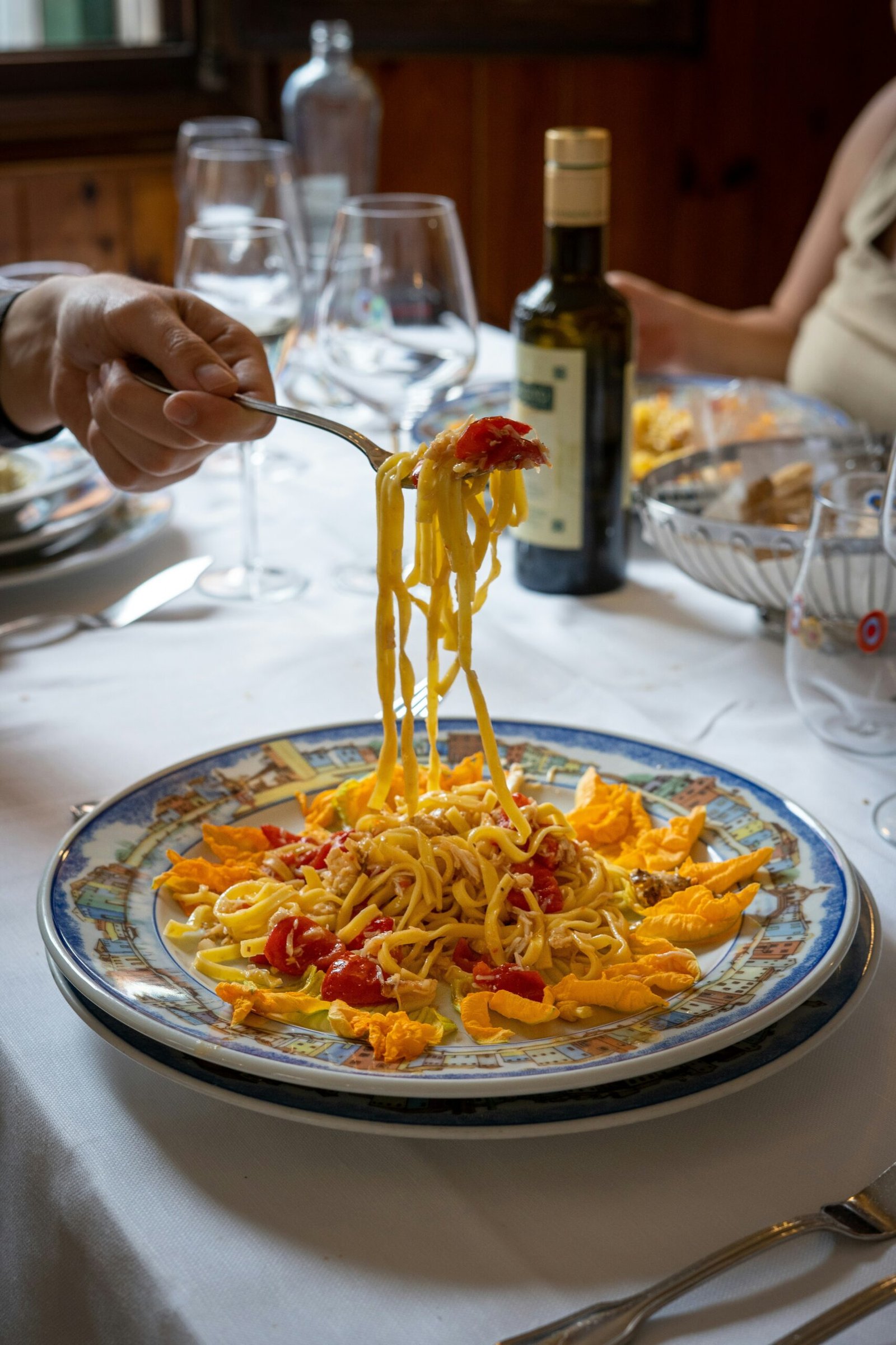 Fresh Mediterranean pasta with cherry tomatoes and squash blossoms, highlighting the healing simplicity of seasonal, plant-based Italian cuisine.