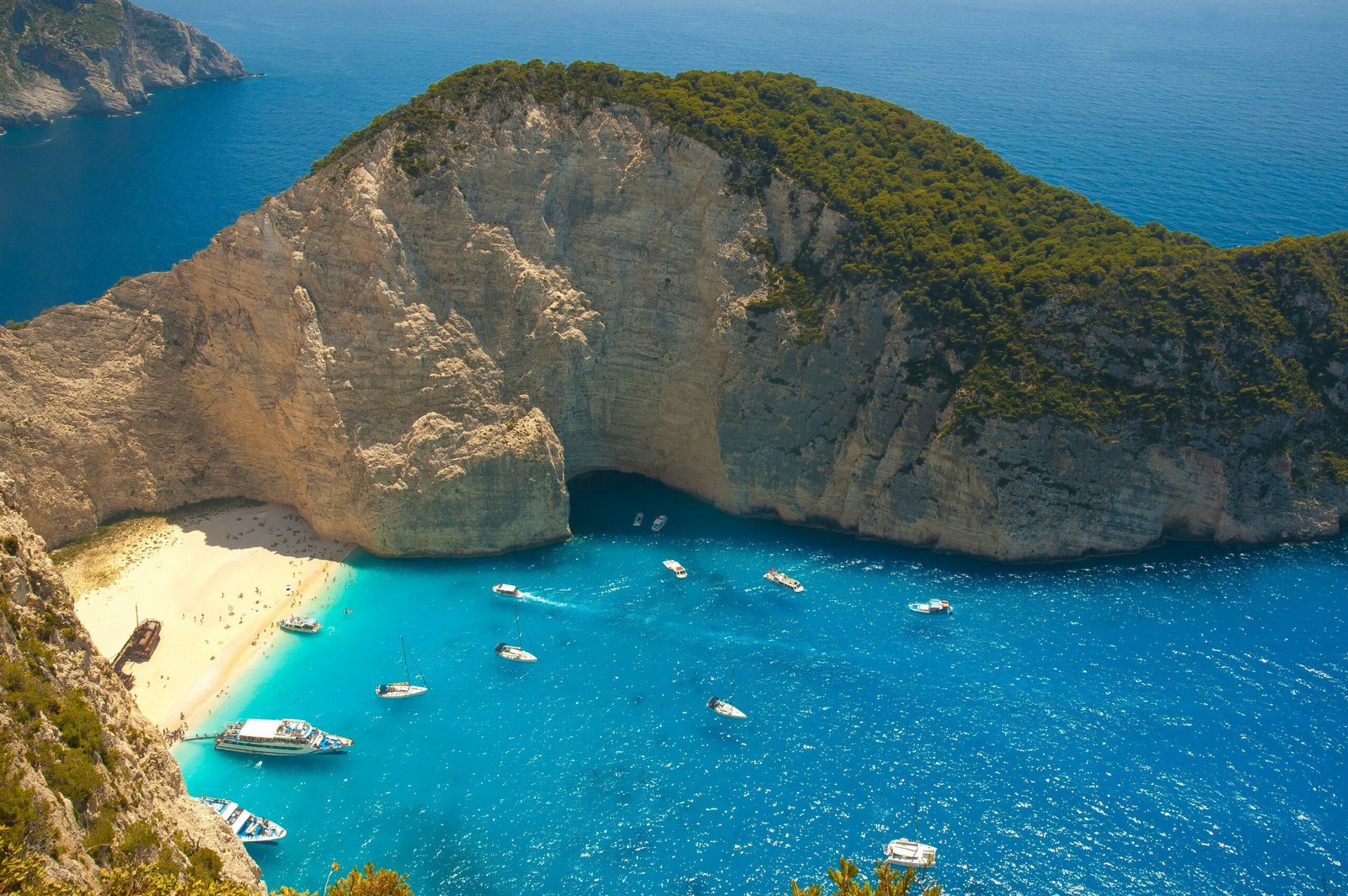 Aerial view of Navagio Beach in Zakynthos, Greece, creating a dramatic and secluded coastal setting for a restorative retreat.