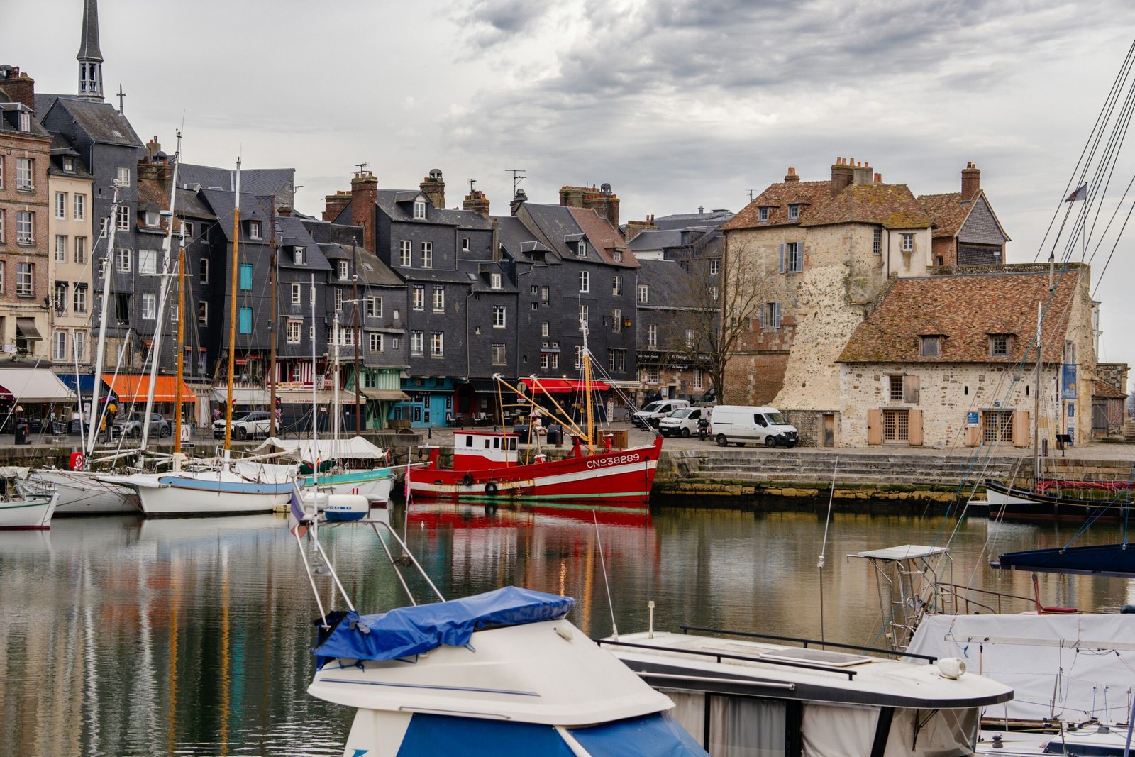 Historic harbor in Honfleur adding a relaxed coastal town atmosphere to a summer yoga retreat in France.