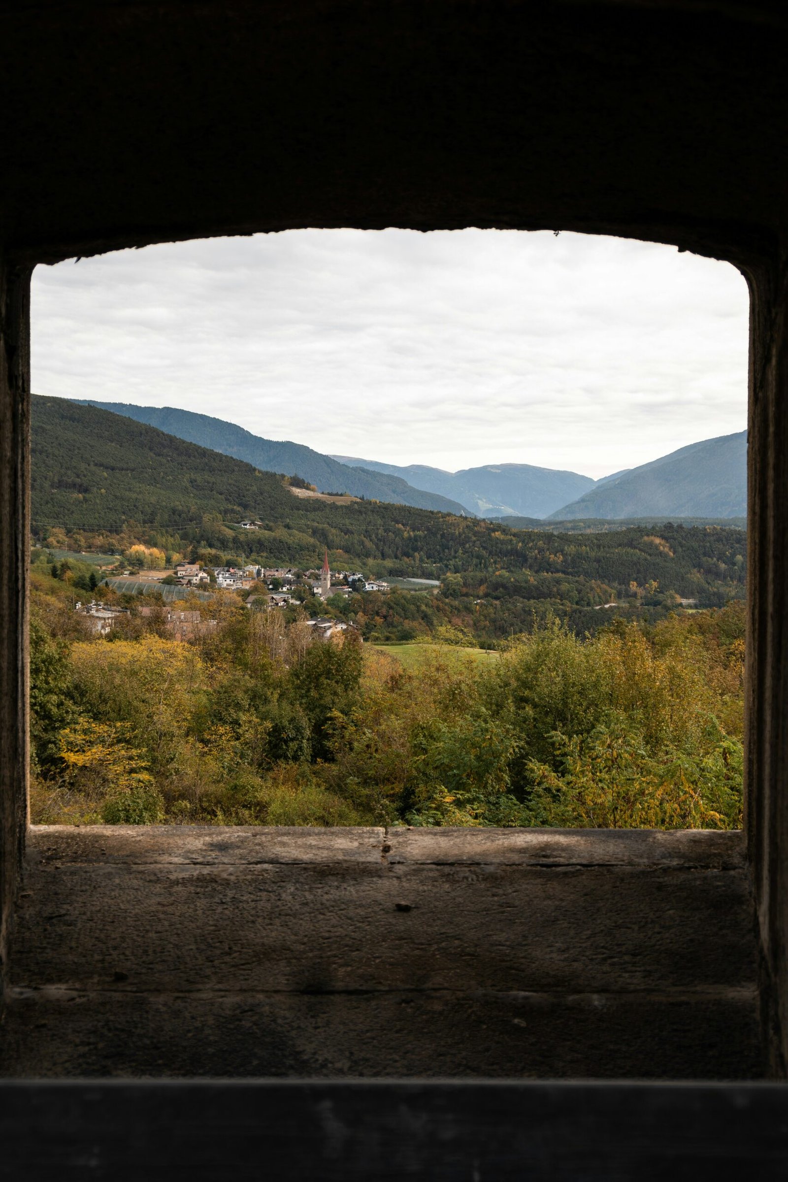 Quiet mountain view through a window in South Tyrol, capturing the inward and contemplative mood of an October retreat.