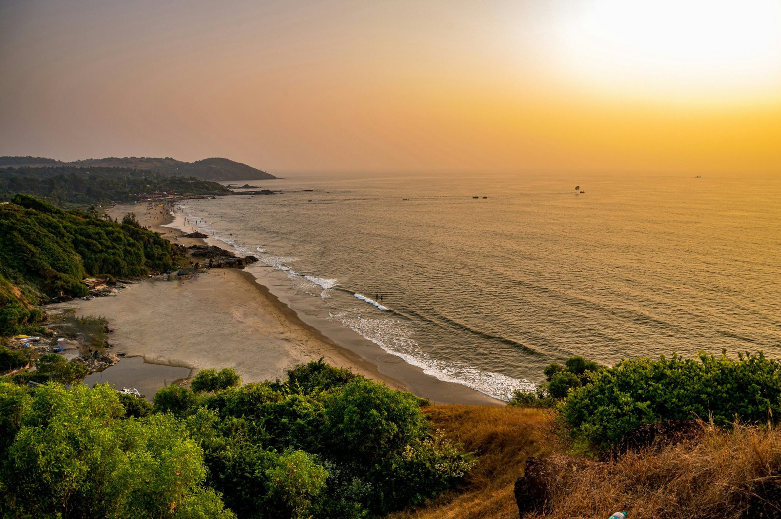 Sunset view over Vagator Beach in Goa, evoking the calm and restorative coastal side of a December retreat in India.