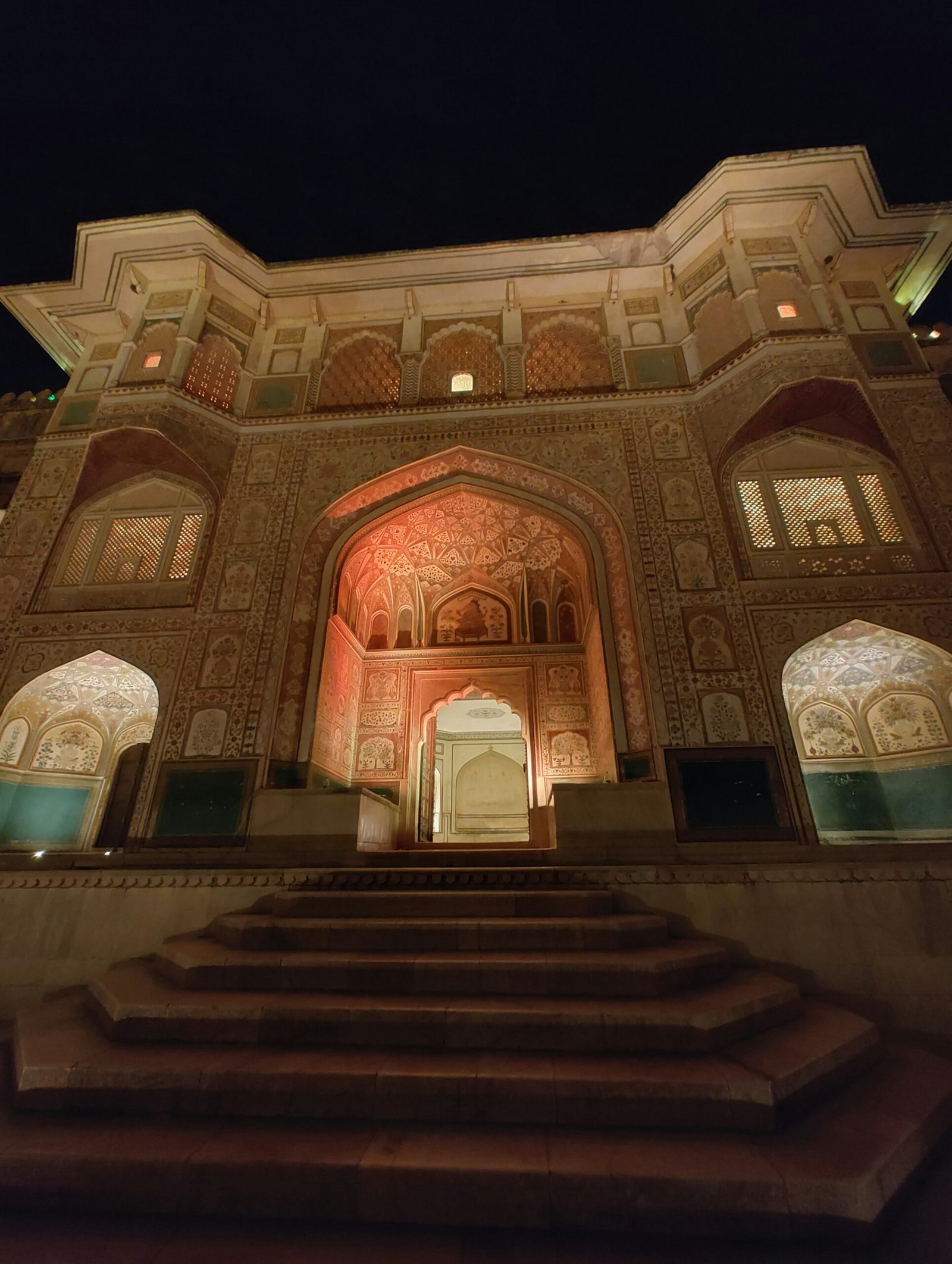 Amer Fort glowing at dusk in Jaipur, evoking the cultural depth and sacred travel element of an India retreat journey