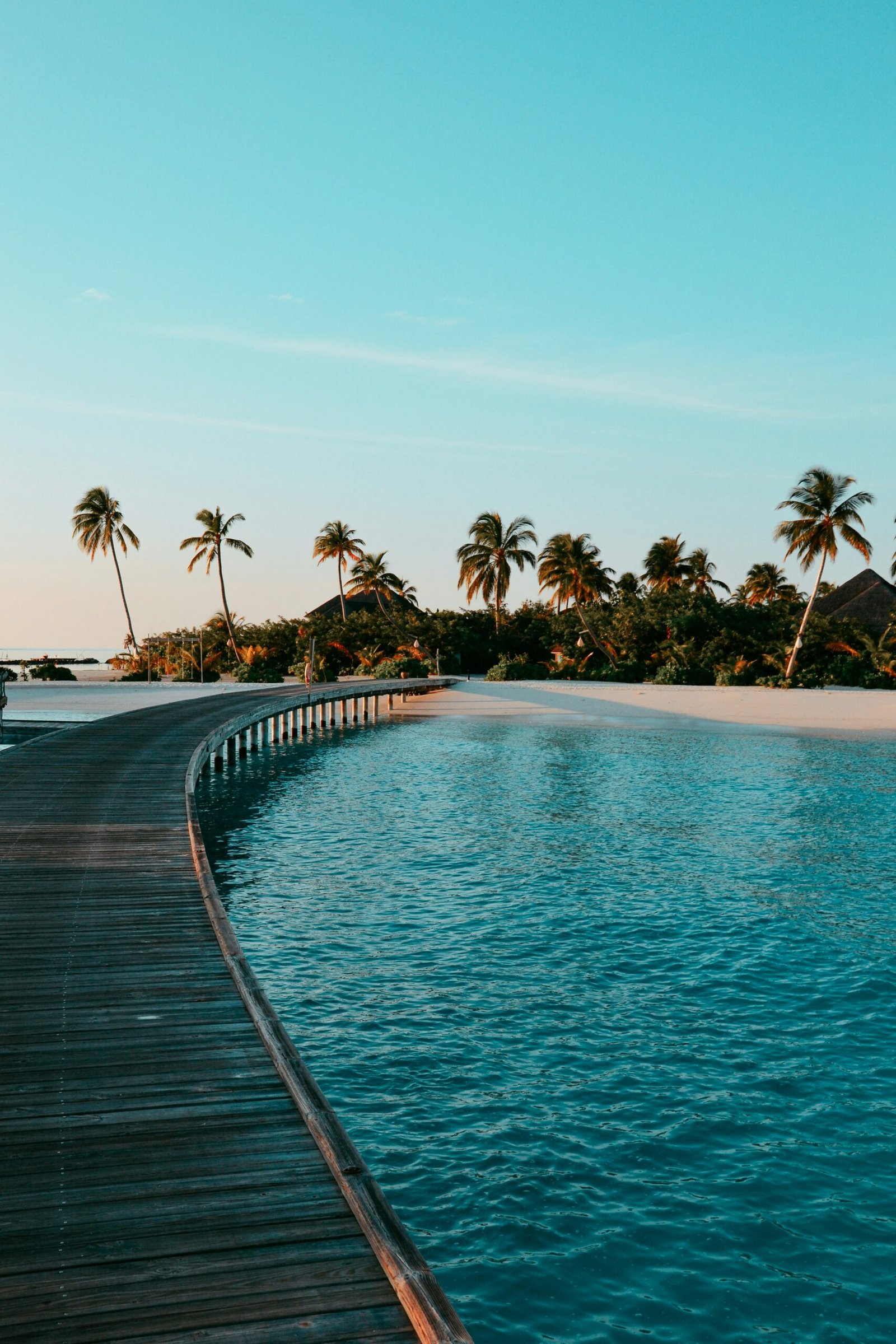 Long wooden dock leading toward the beach at a quiet retreat destination made for reflection and reset