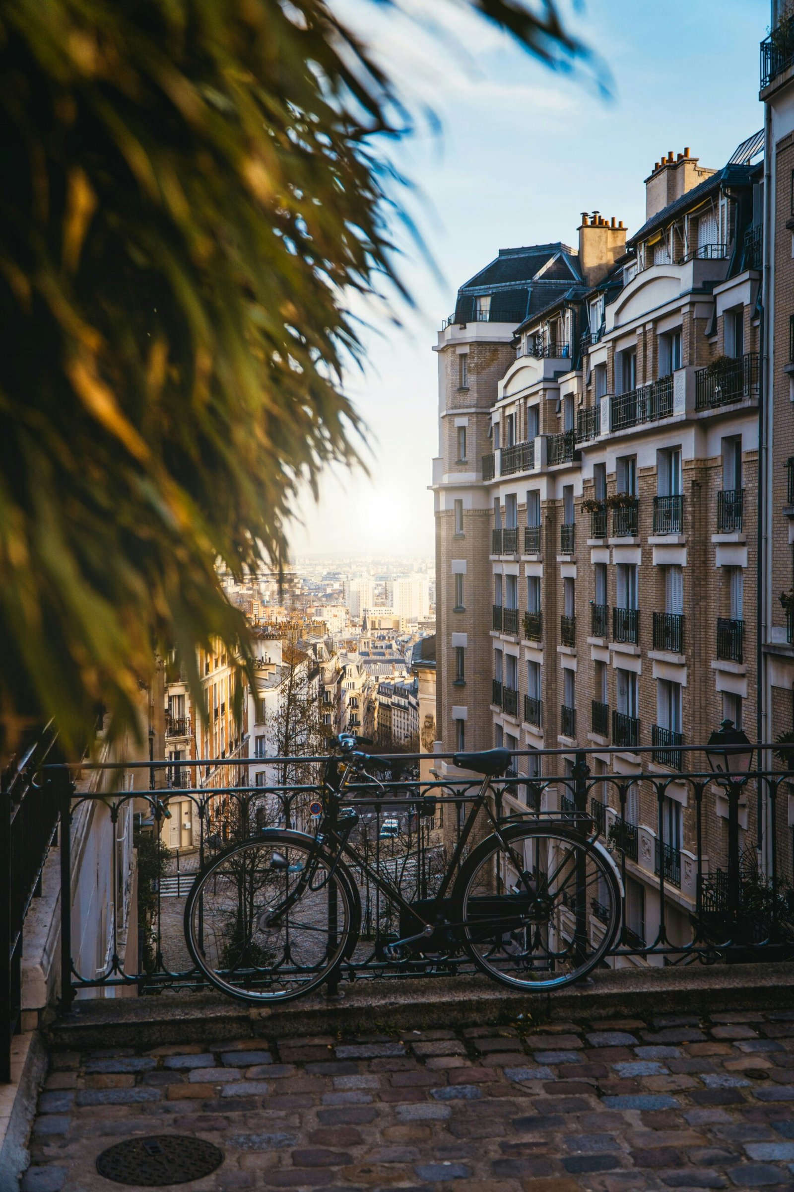 Black bicycle beside a fence in Montmartre, Paris, bringing a slow and charming city moment to a France yoga retreat experience.