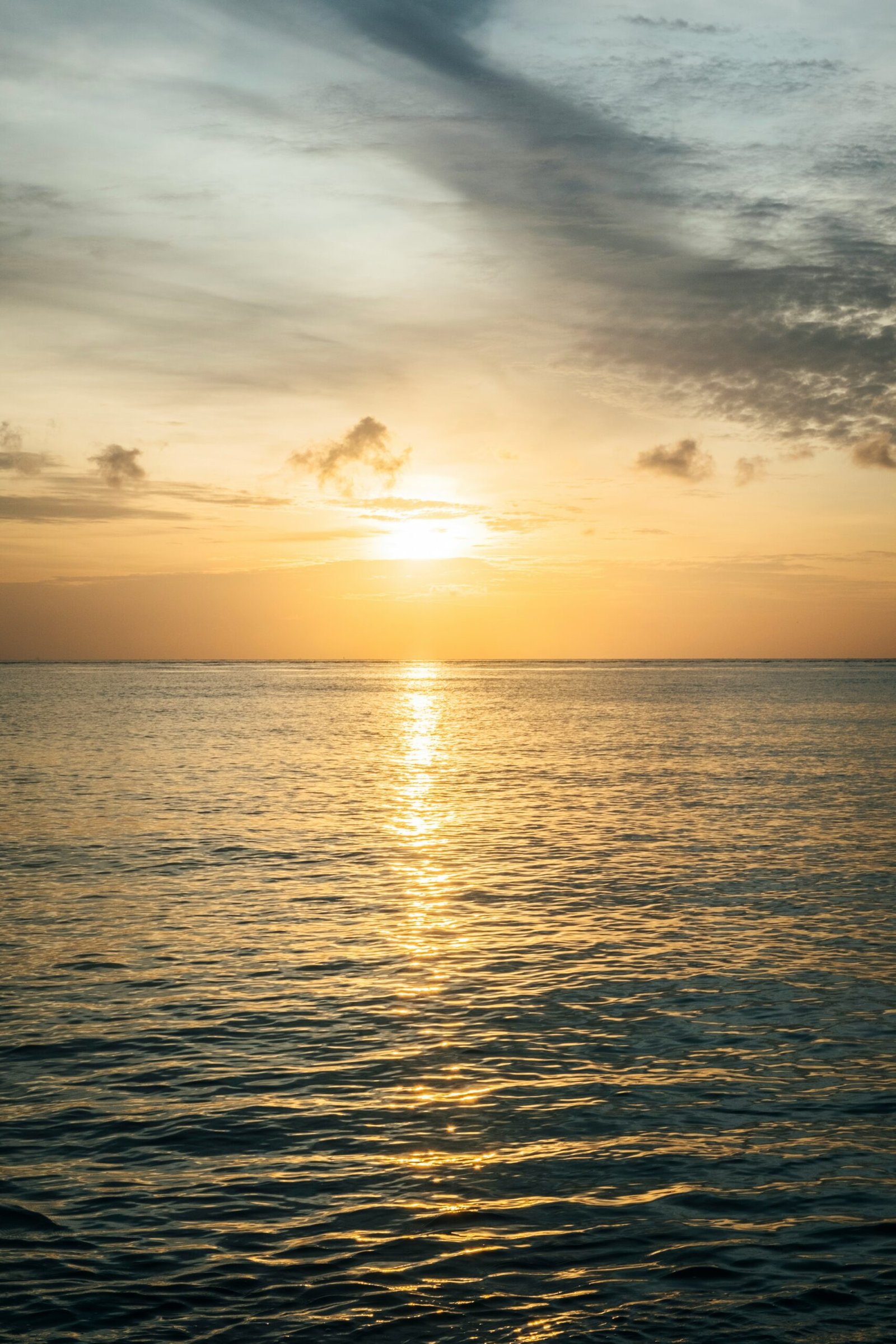 gentle sunset over amed beach with warm sea and quiet evening light