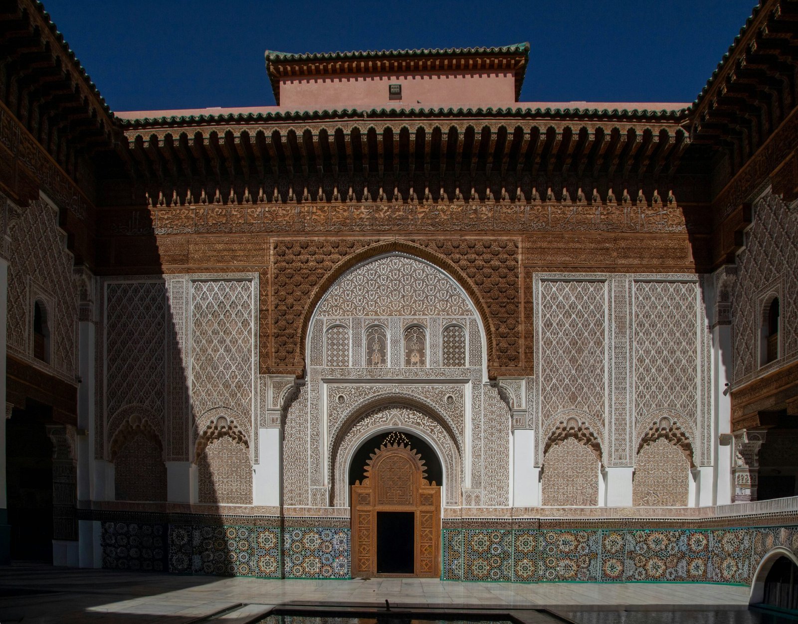 ornate marrakech courtyard with tiled arches and still afternoon shade