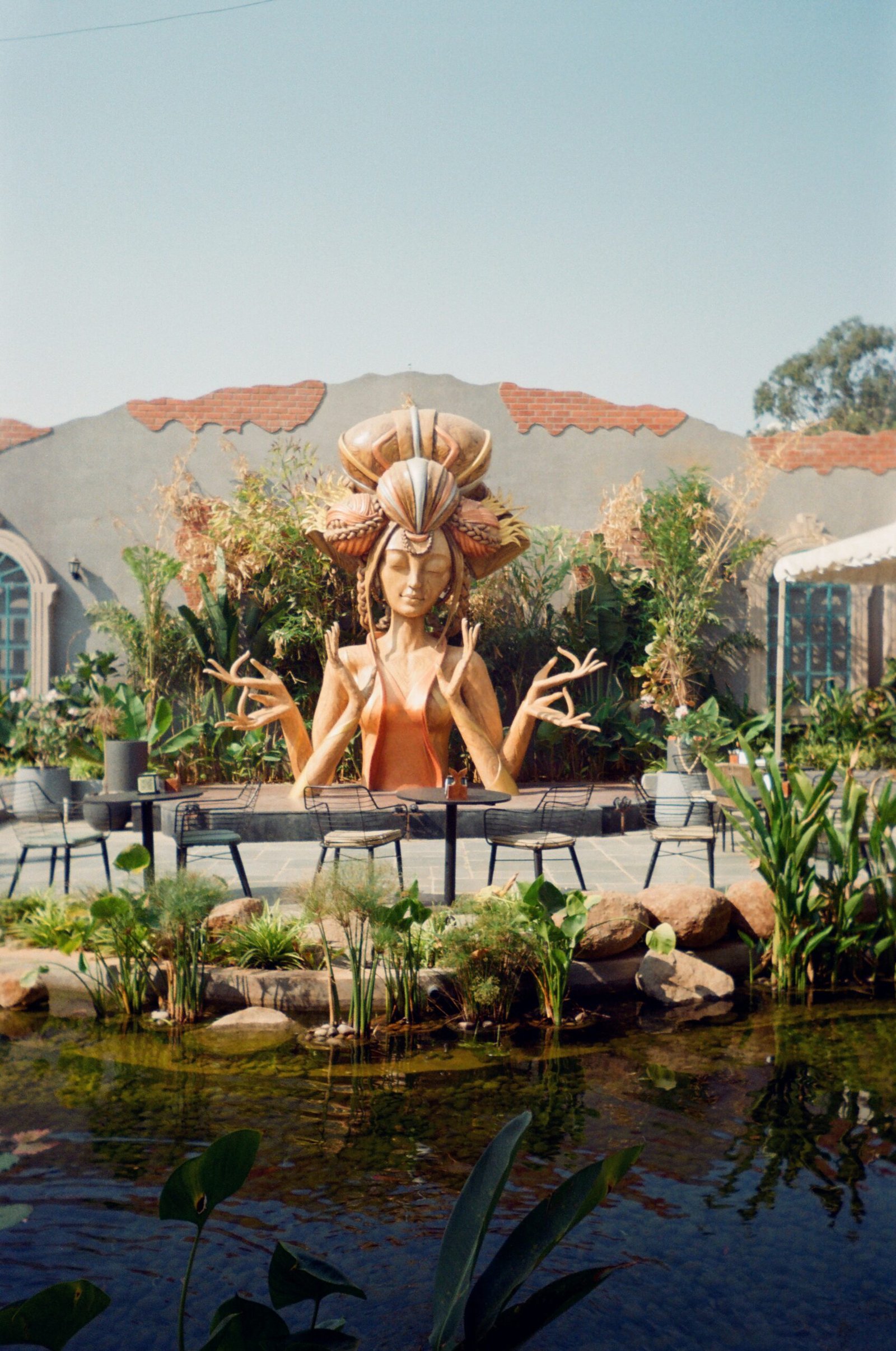 Statue beside a quiet pond in Bengaluru, reflecting the contemplative and spiritual mood of a yoga retreat in India.