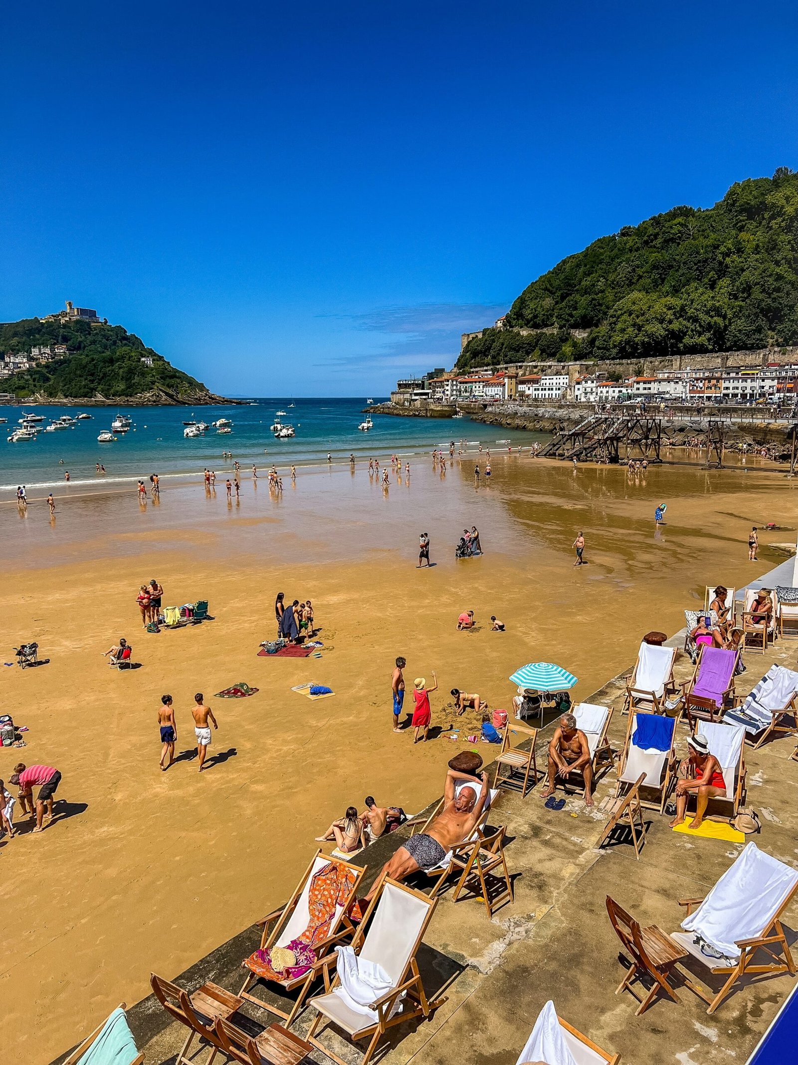 Beach and boats in San Sebastián, Basque Country, Spain, during a lively summer day