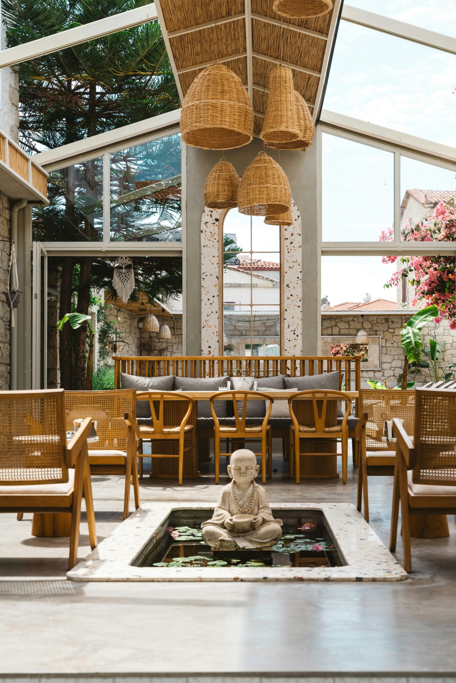 Quiet room with wooden chairs and a Buddha statue, reflecting the meditative and mindful atmosphere of a retreat gathering space.