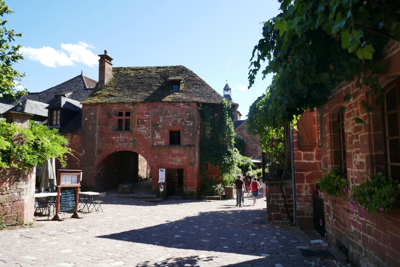Red-brick village square in Collonges-la-Rouge, bringing a warm and peaceful countryside feel to a France yoga retreat.