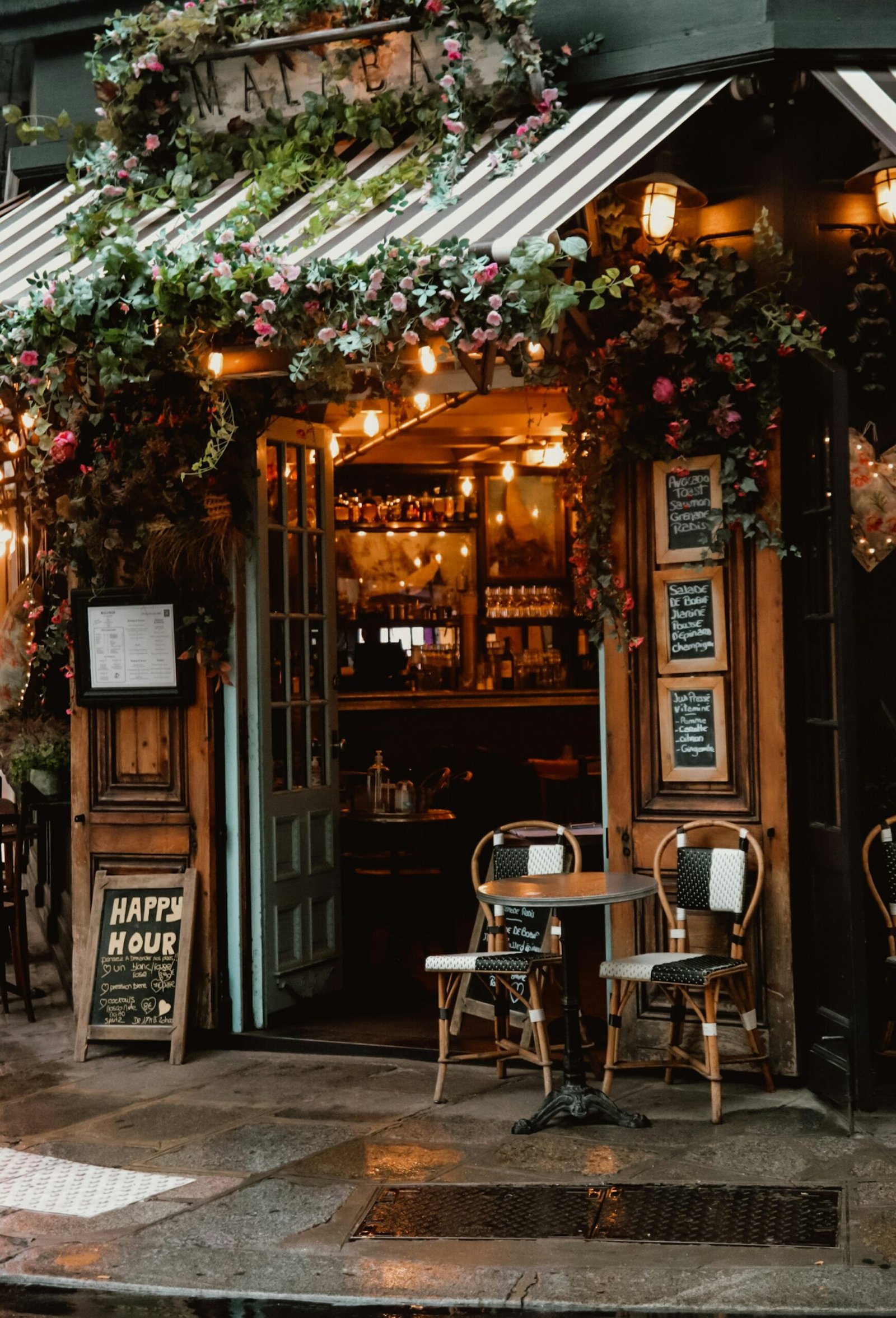Evening cafe terrace in Paris after a day at a France yoga retreat, with warm string lights and a relaxed summer atmosphere.