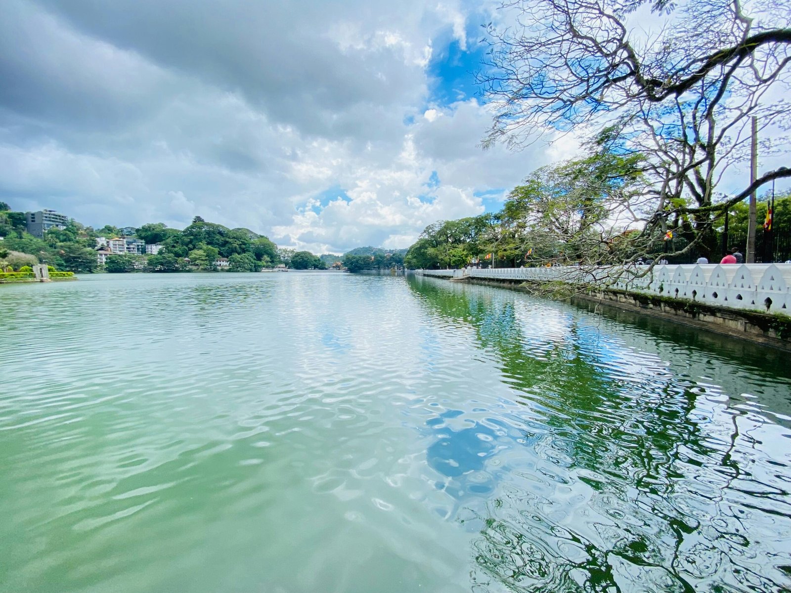 Peaceful view across Kandy Lake with buildings and trees in central Sri Lanka