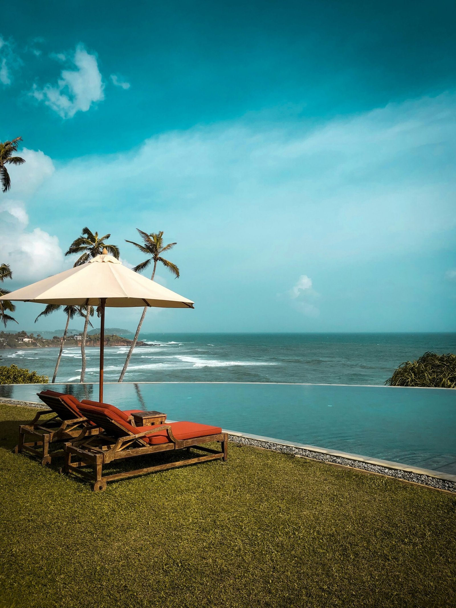 Lounge chairs beside the shore at Cape Weligama, Sri Lanka, capturing the restful and restorative mood of a seaside yoga retreat.