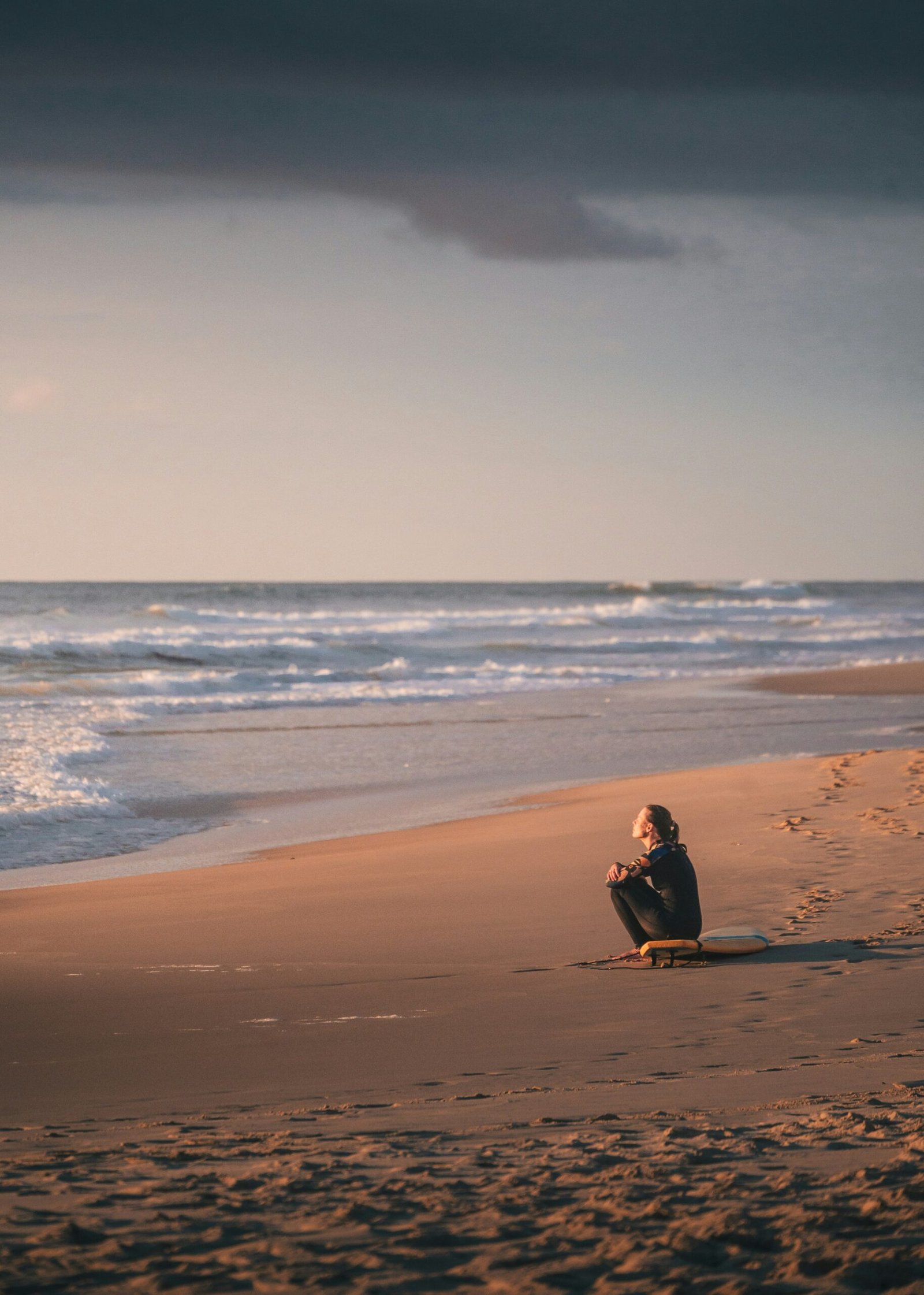 person meditating by the sea in porto portugal during a may wellness retreat
