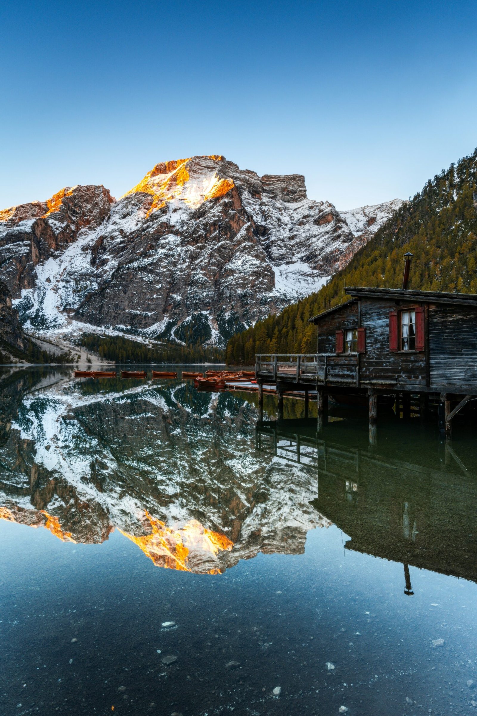 Mountain range reflected in a calm lake creating a serene retreat setting for reflection, balance, and deep rest