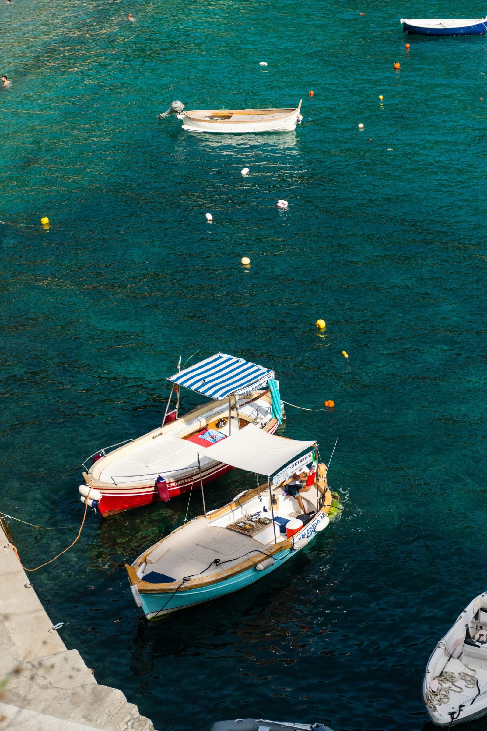 Boats floating on calm blue water for a serene coastal retreat atmosphere shaped by stillness and gentle escape