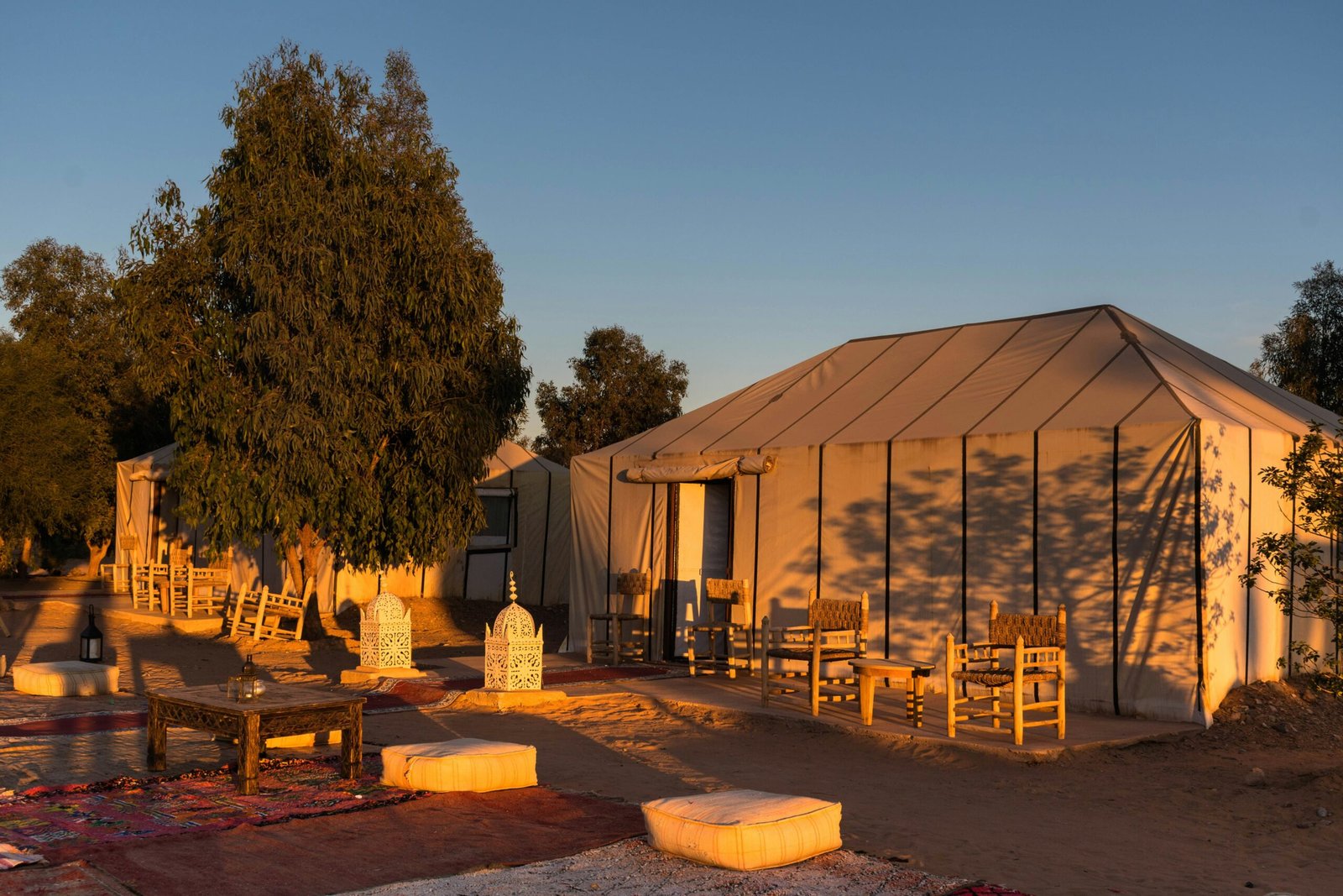 Minimalist tent in an open field offering a simple outdoor retreat experience focused on rest and reset