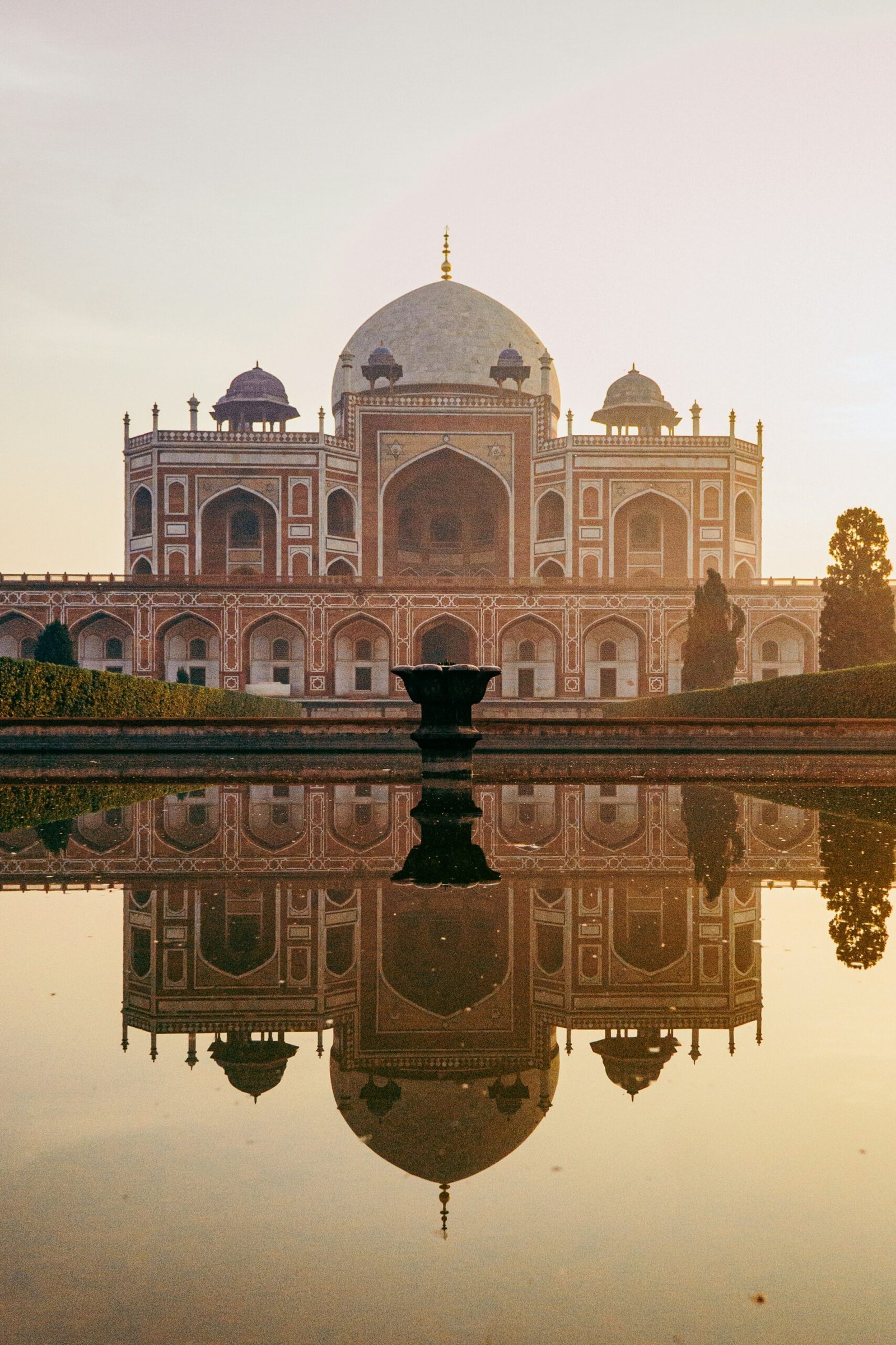 Reflection of Humayun’s Tomb in water in New Delhi, evoking a calm and reflective retreat experience