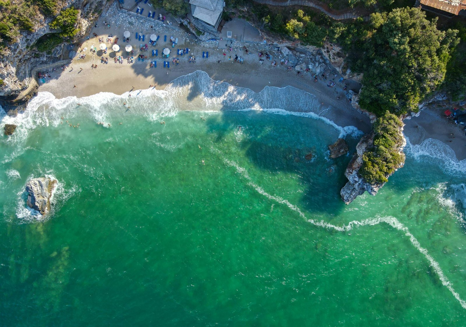 Mylopotamos beach in Pelion with clear water and rugged shoreline for a nature-led retreat by the coast.