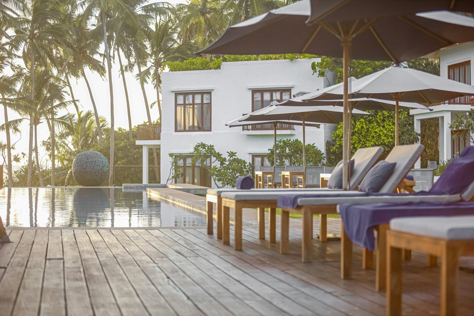 Coastal retreat setting at Kumu Beach in Balapitiya with poolside views and palm trees.