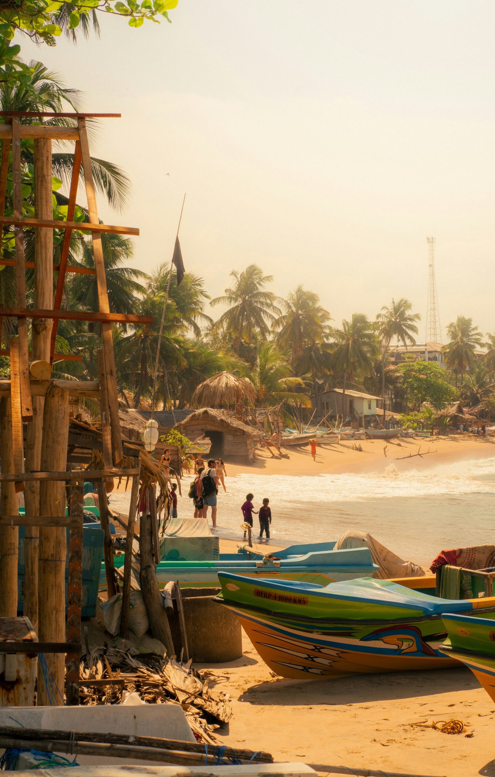 Boats resting on the shore in Arugam Bay, Sri Lanka, suited to a June retreat that blends beach practice with ocean rhythm.