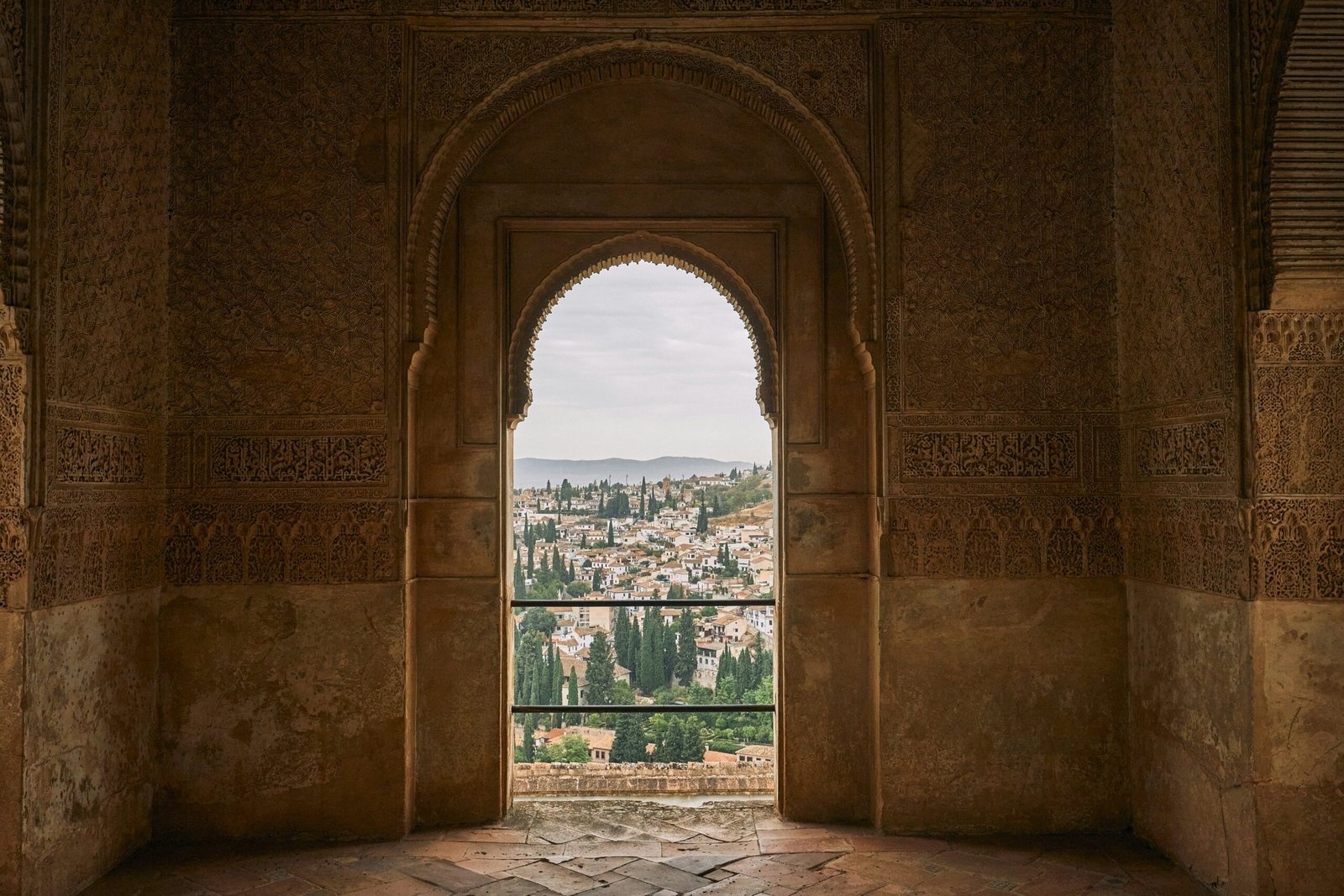 View over Granada, Spain, framed by an interior archway and historic stone architecture