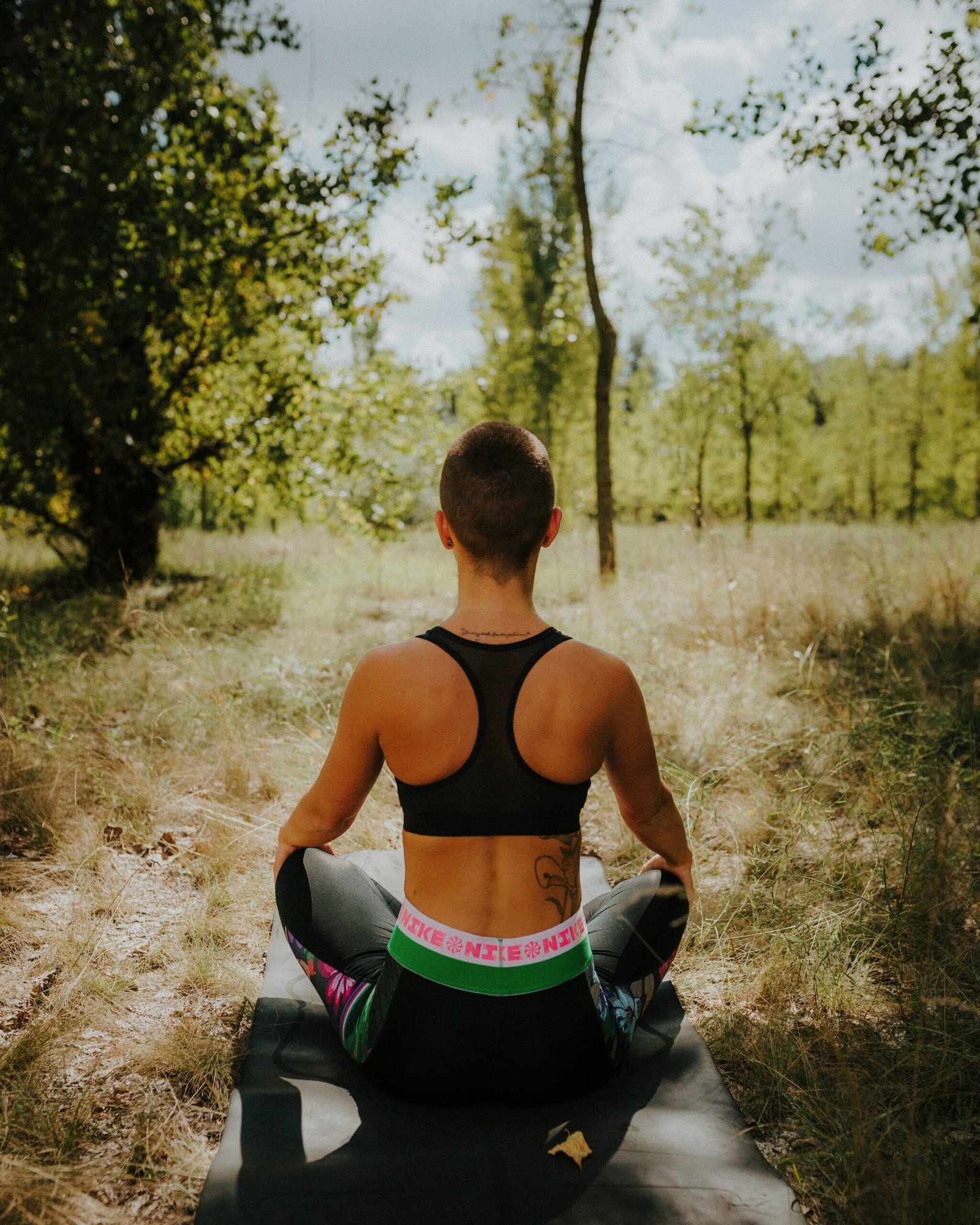 woman doing yoga in nature in autumn
