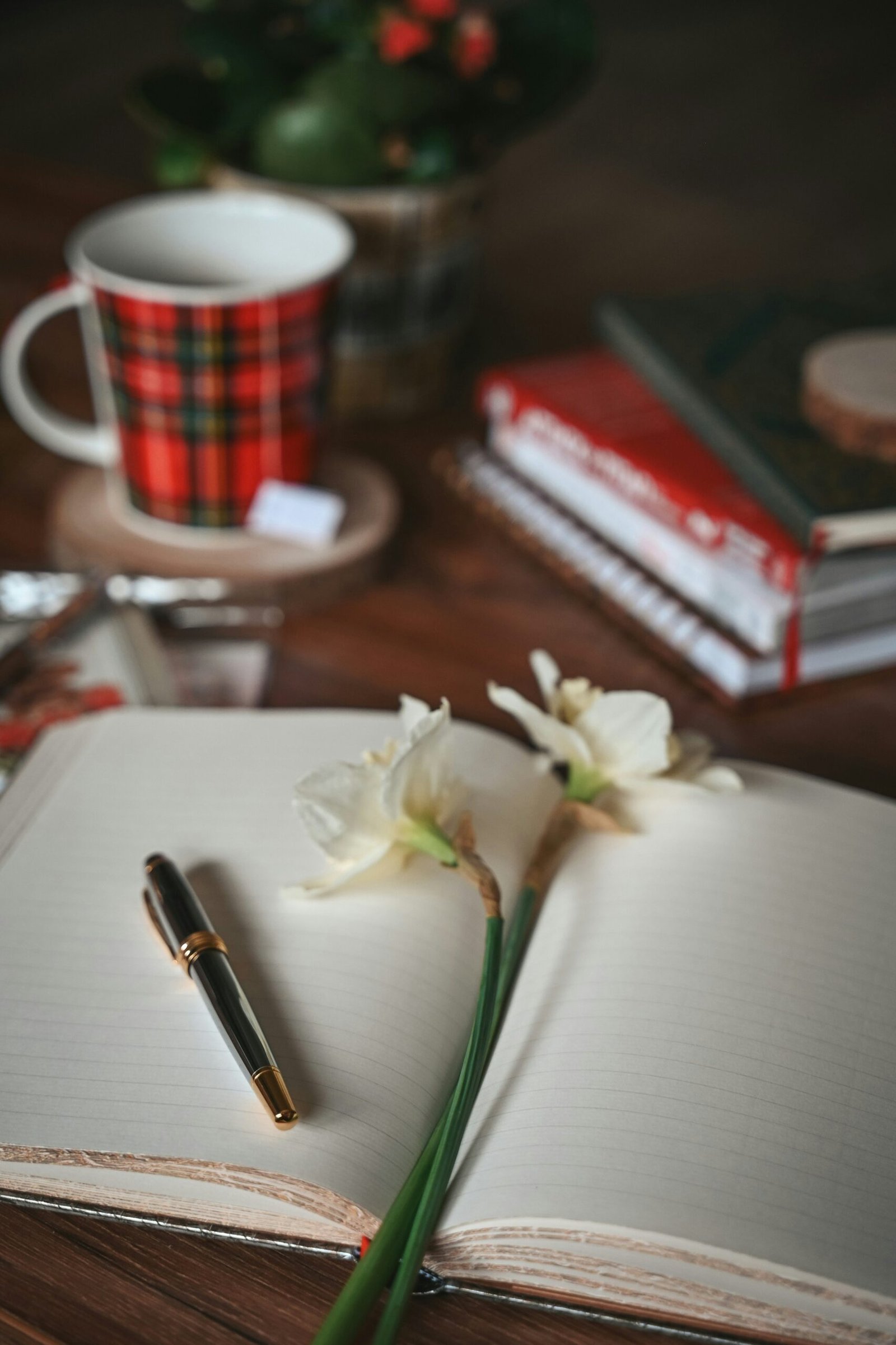 Open notebook with flowers on the table for reflective journaling during a May retreat.