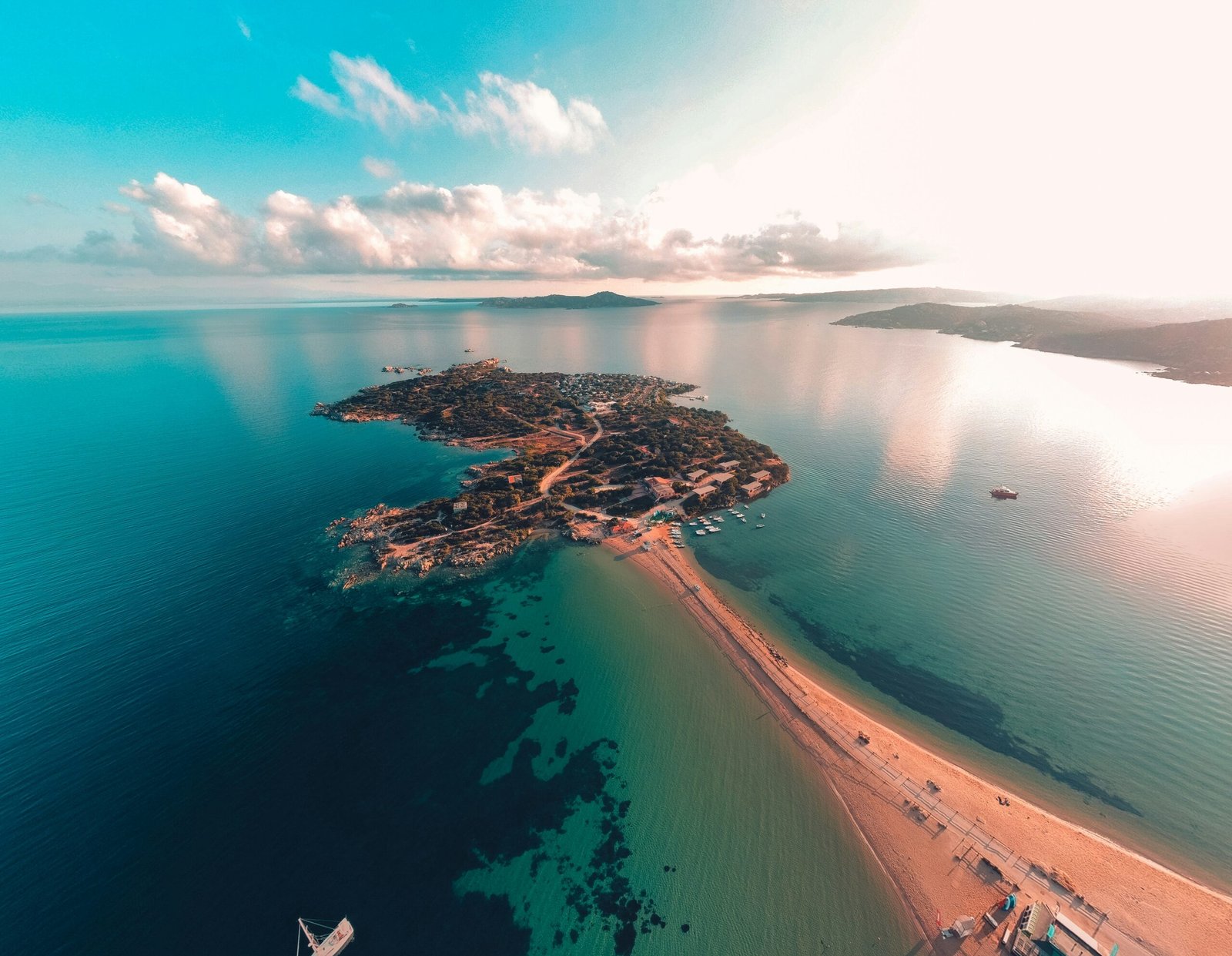 Aerial coastal view with bright water and open shoreline suited to a light June retreat escape