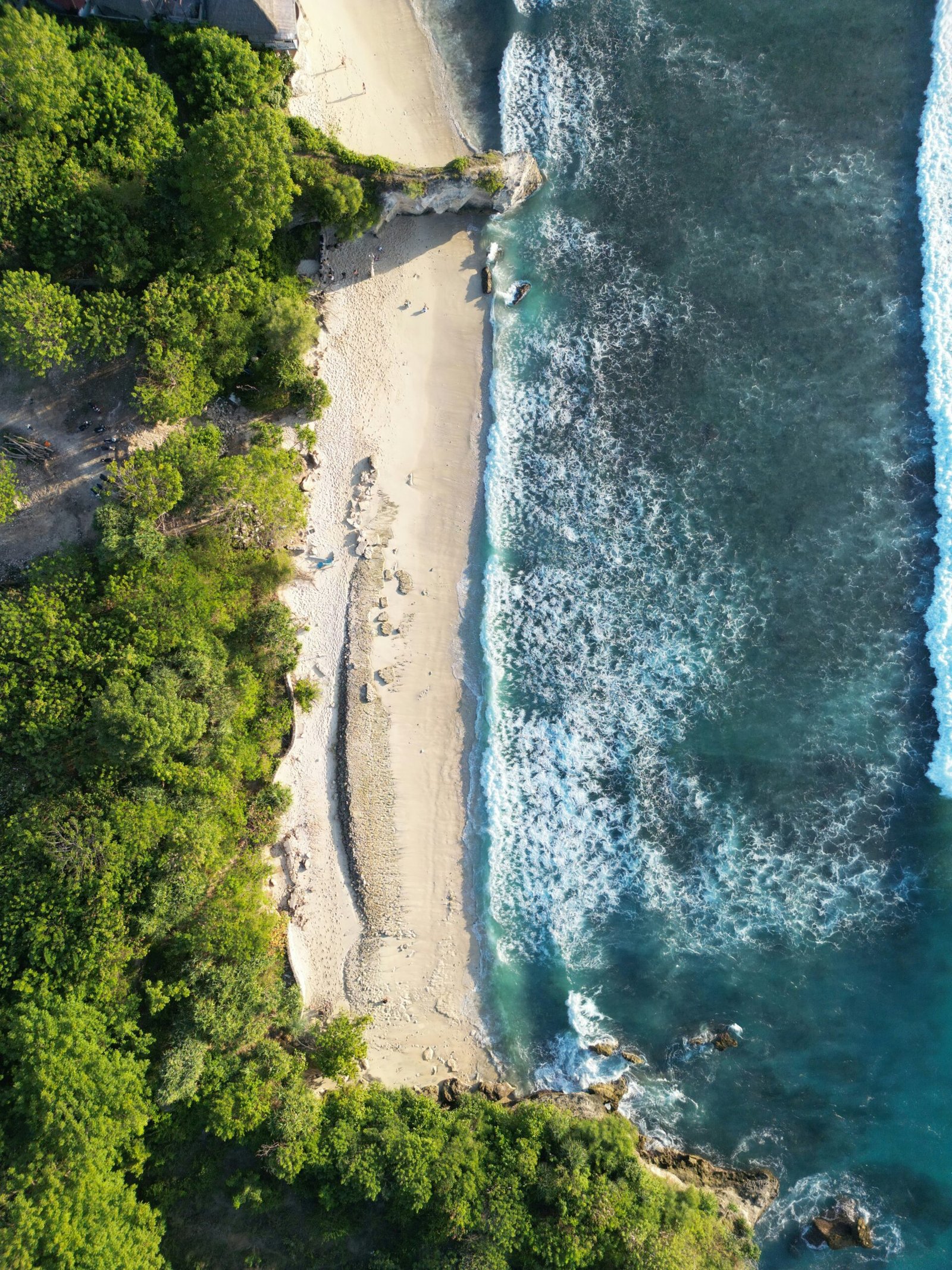 A luxury oceanfront resort in Bali featuring a traditional tiered roof and infinity pool overlooking the Indian Ocean during a sunny Summer 2026 yoga retreat.