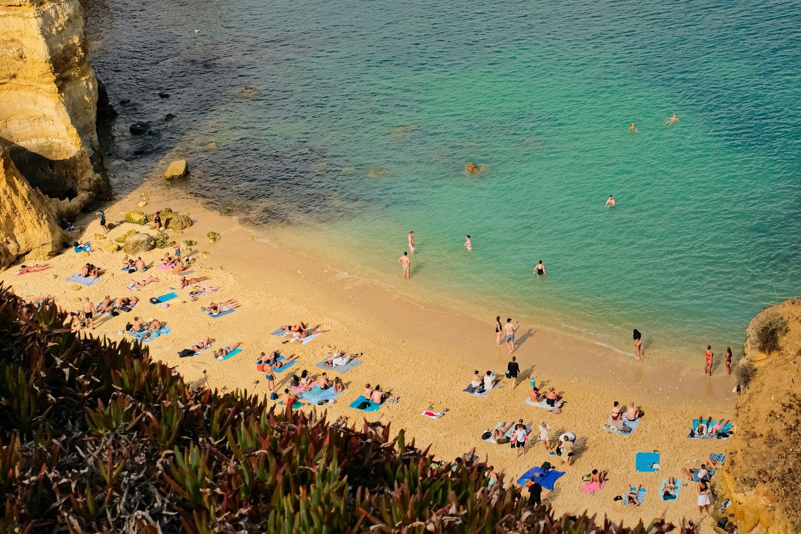 busy summer beach in lagos portugal during the august retreat season