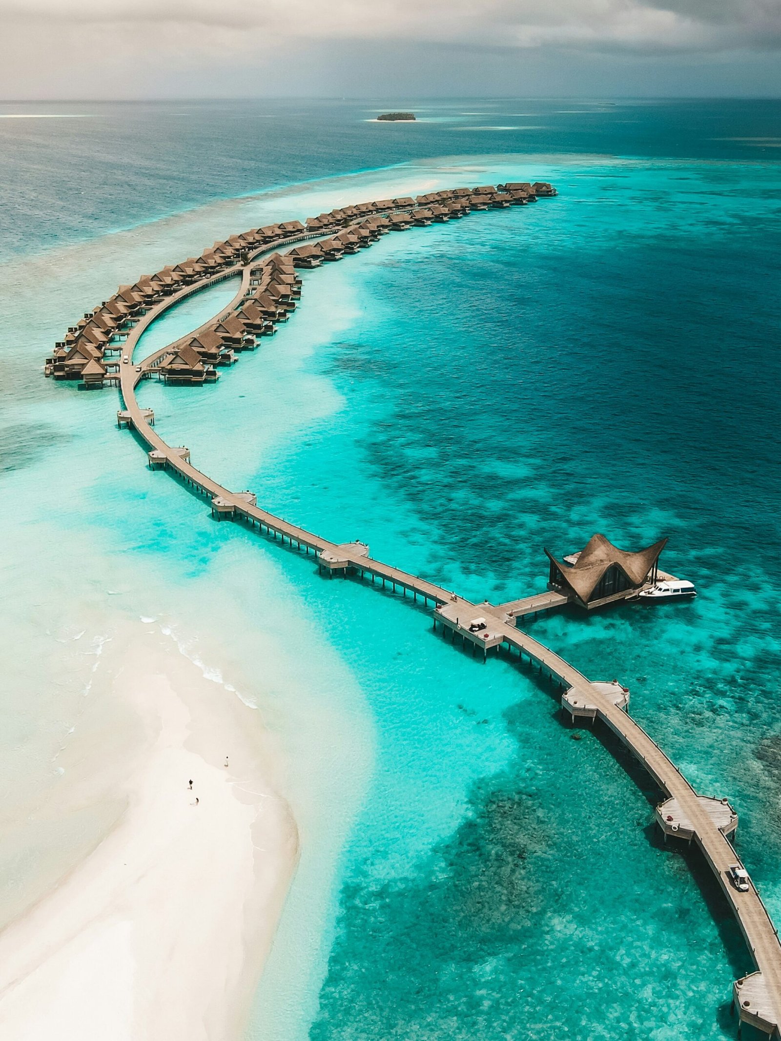 Overwater villas in the Maldives above clear turquoise water with a serene luxury resort feel.