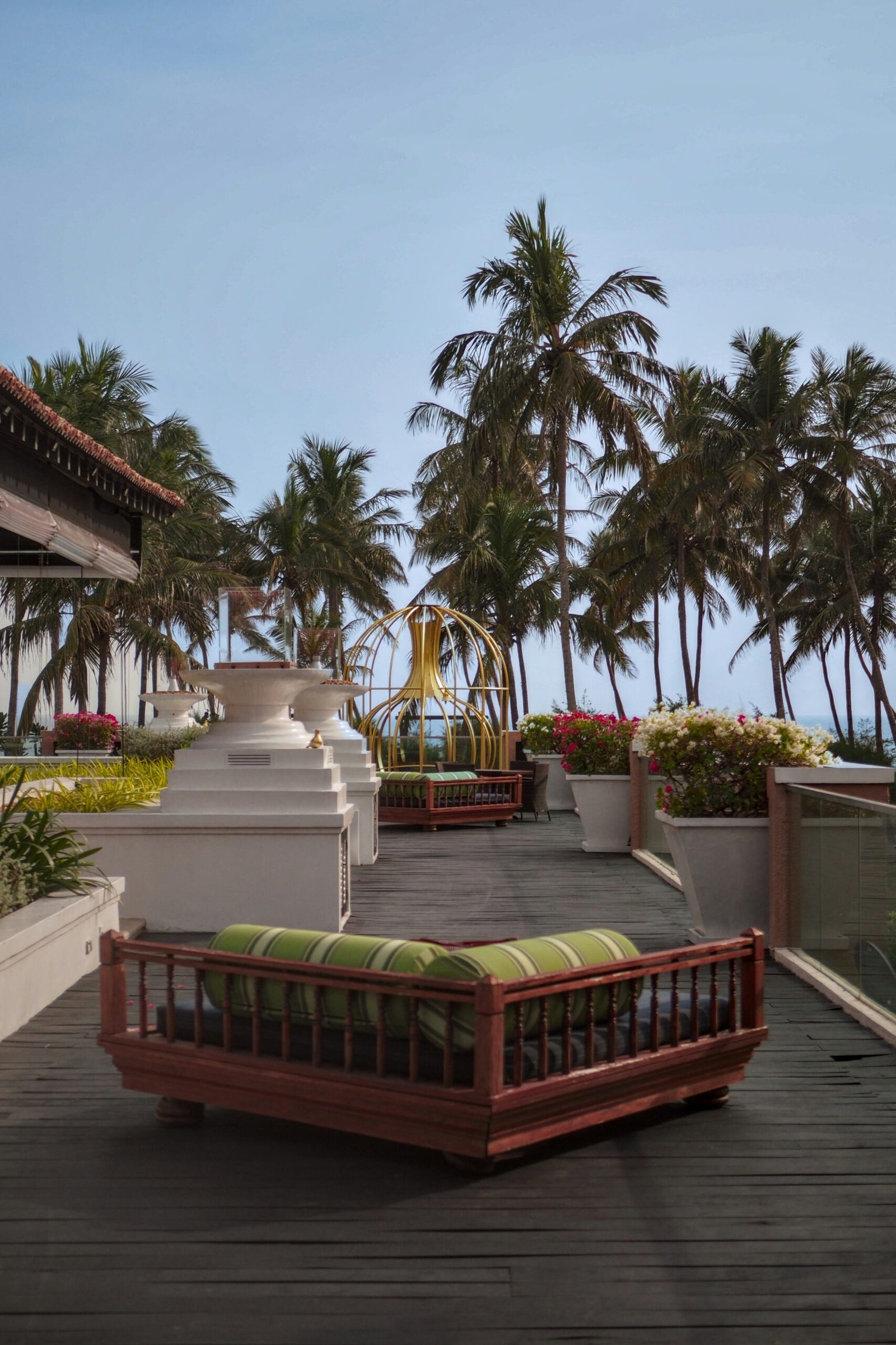 Outdoor seating area in Hambantota with palm trees and ocean views, offering a peaceful setting for a Sri Lanka ayurveda retreat.