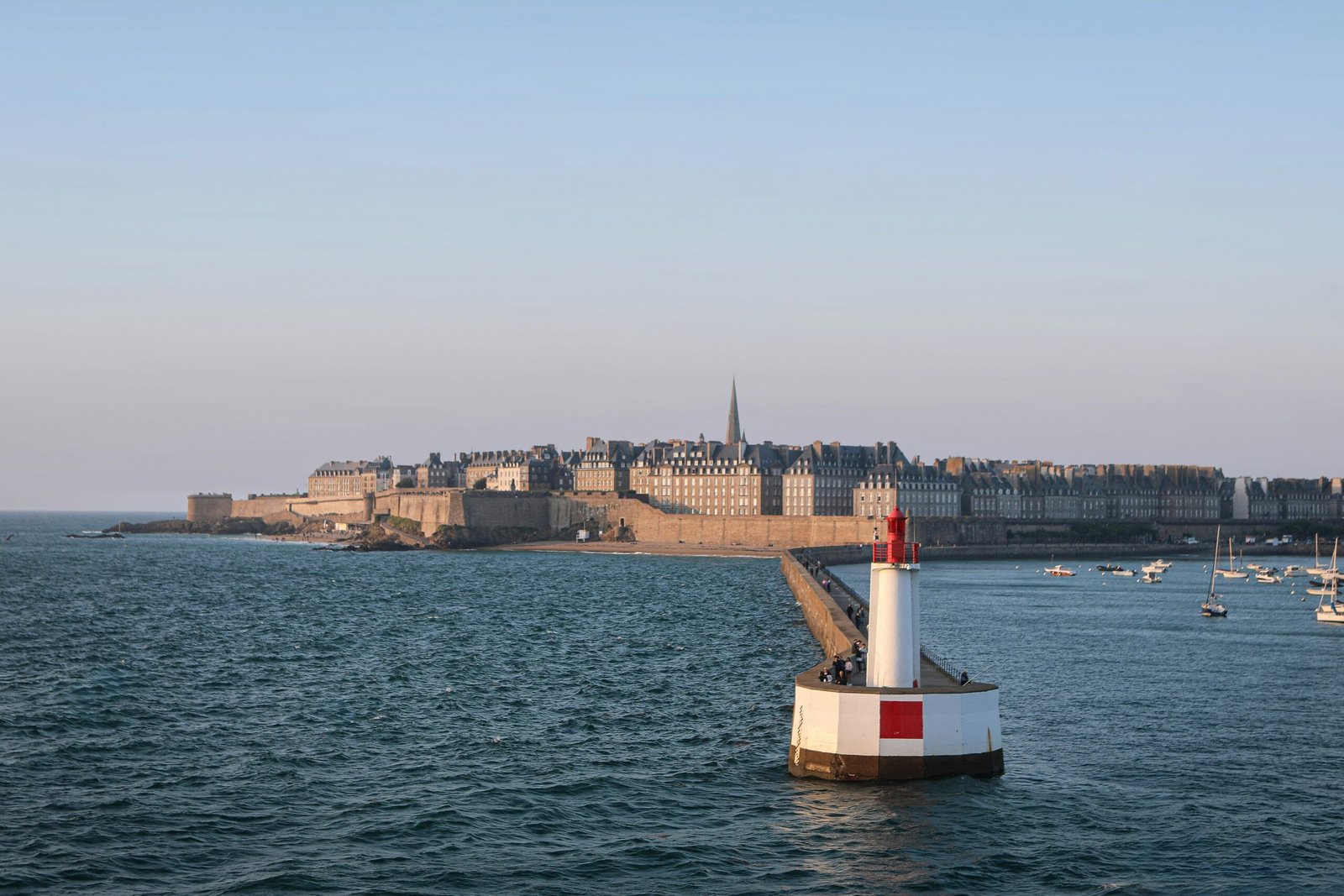 Coastal view of Saint-Malo with sea walls and lighthouse, adding a breezy historic feel to a France yoga retreat.