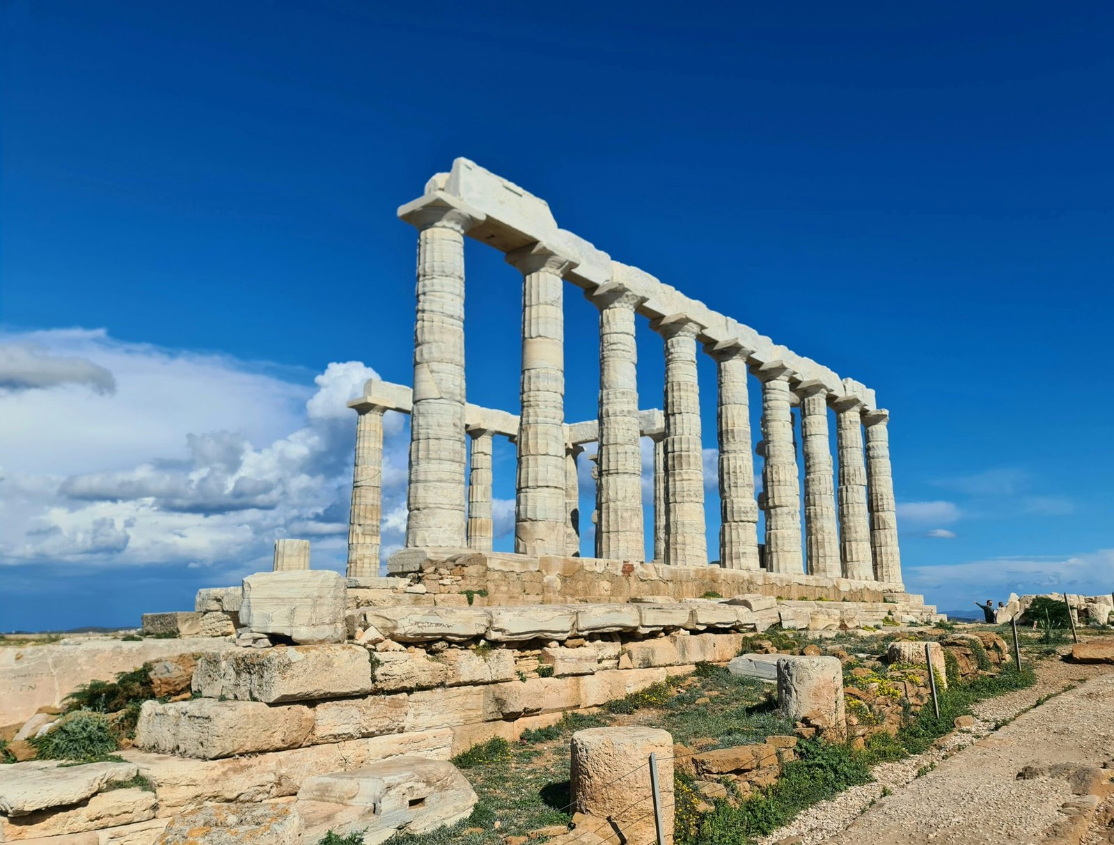 Temple of Poseidon at Sounion under bright spring skies, suited to a Greece retreat with open sea views and grounding energy.
