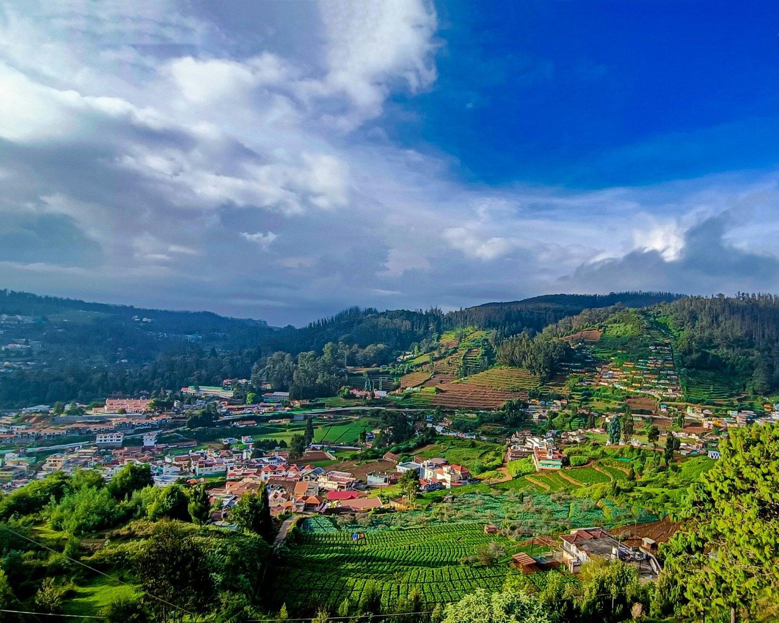 Hillside town view in Ooty, showing the gentle hill-station scenery that suits a restful winter retreat in India.