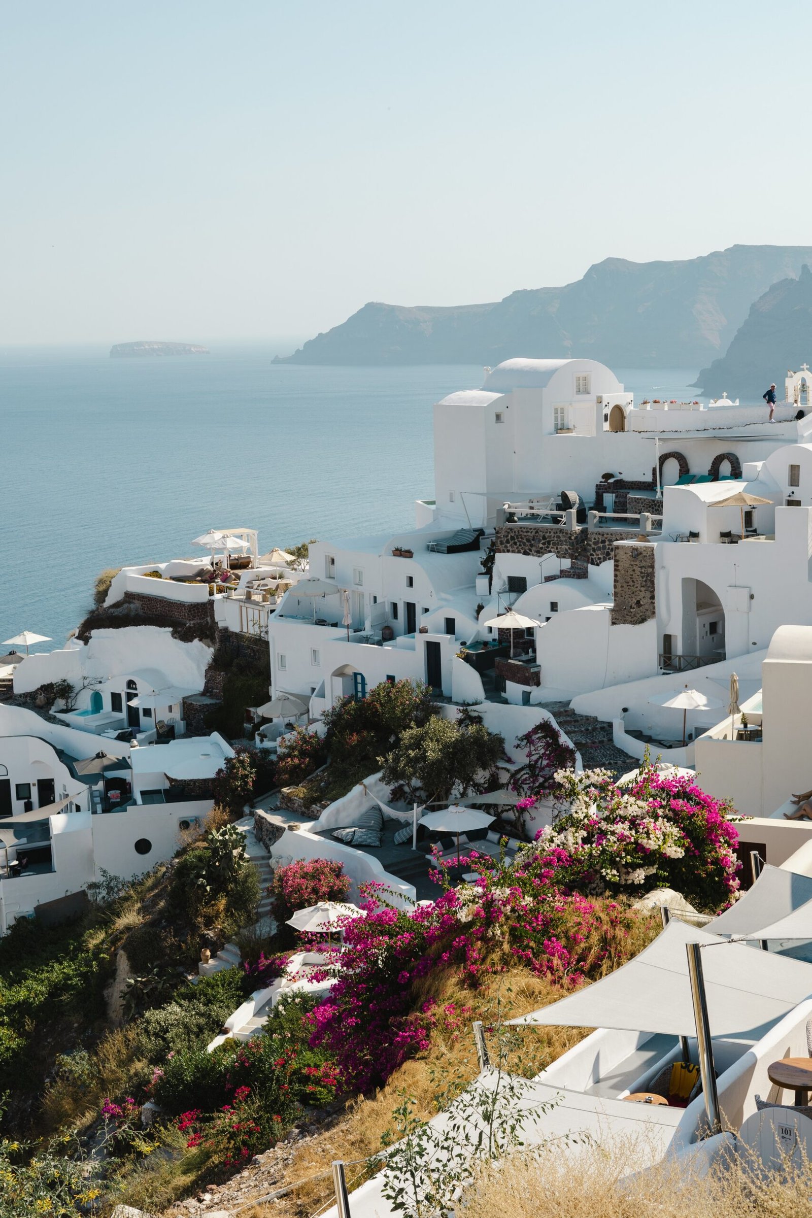 White coastal village in Greece with open sea views, fitting a quiet and restorative October retreat atmosphere.