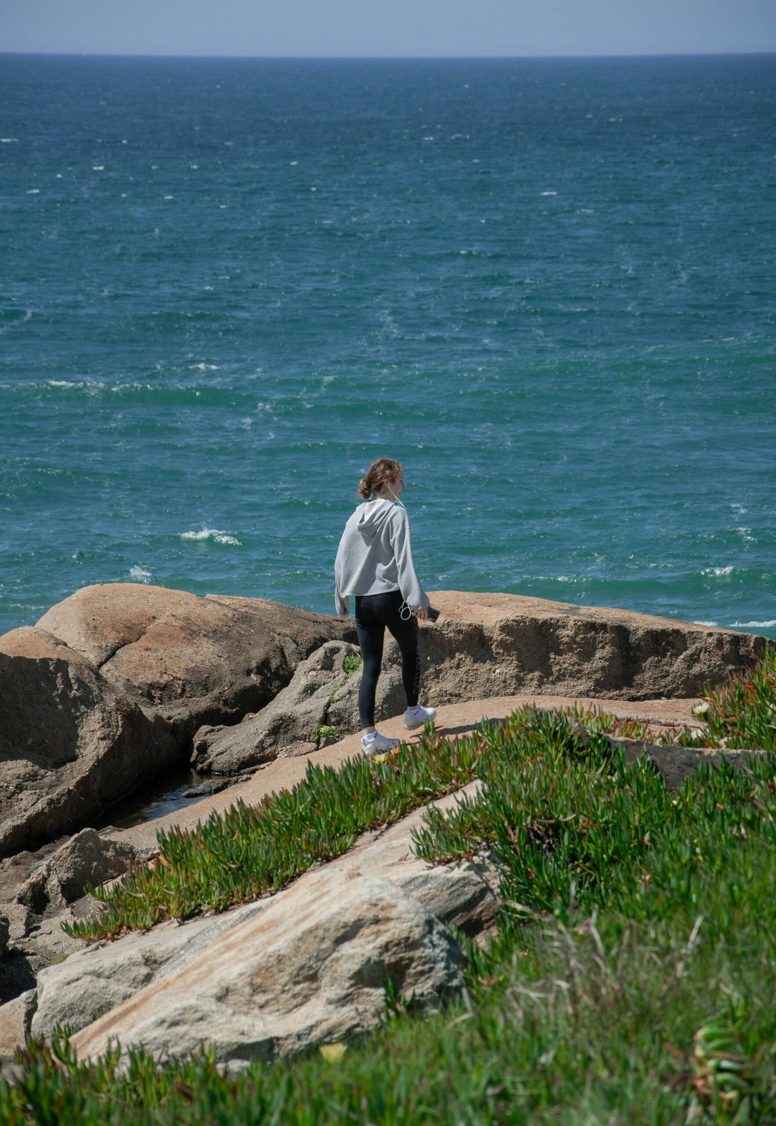 person meditating by the sea in porto portugal during a september wellness retreat