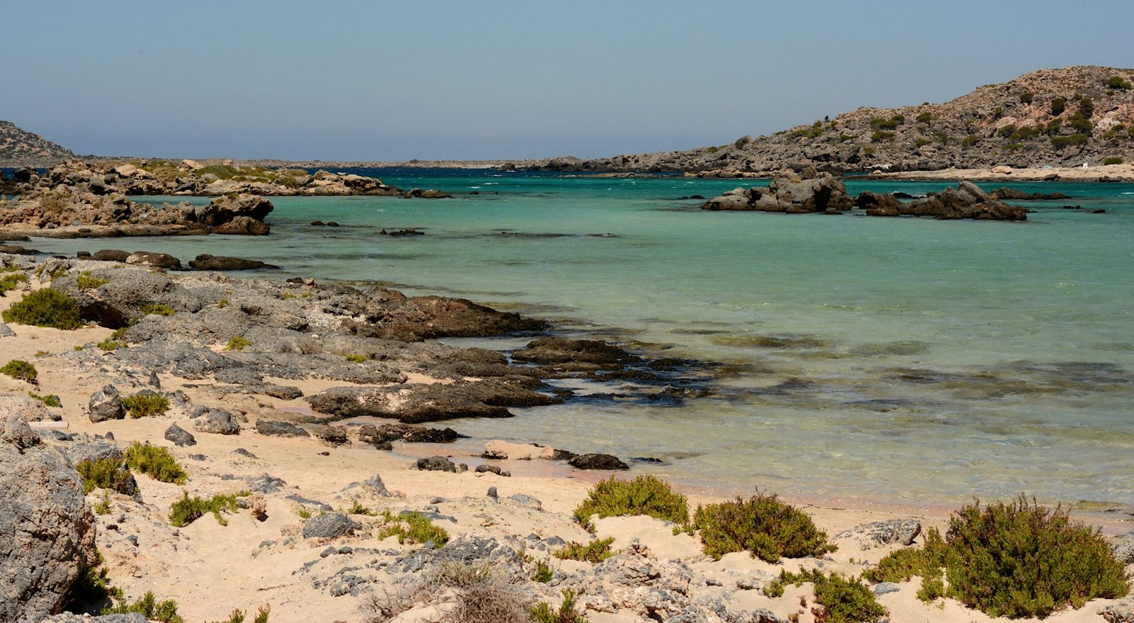 Rocky shoreline and clear blue water on the coast of Crete, Greece