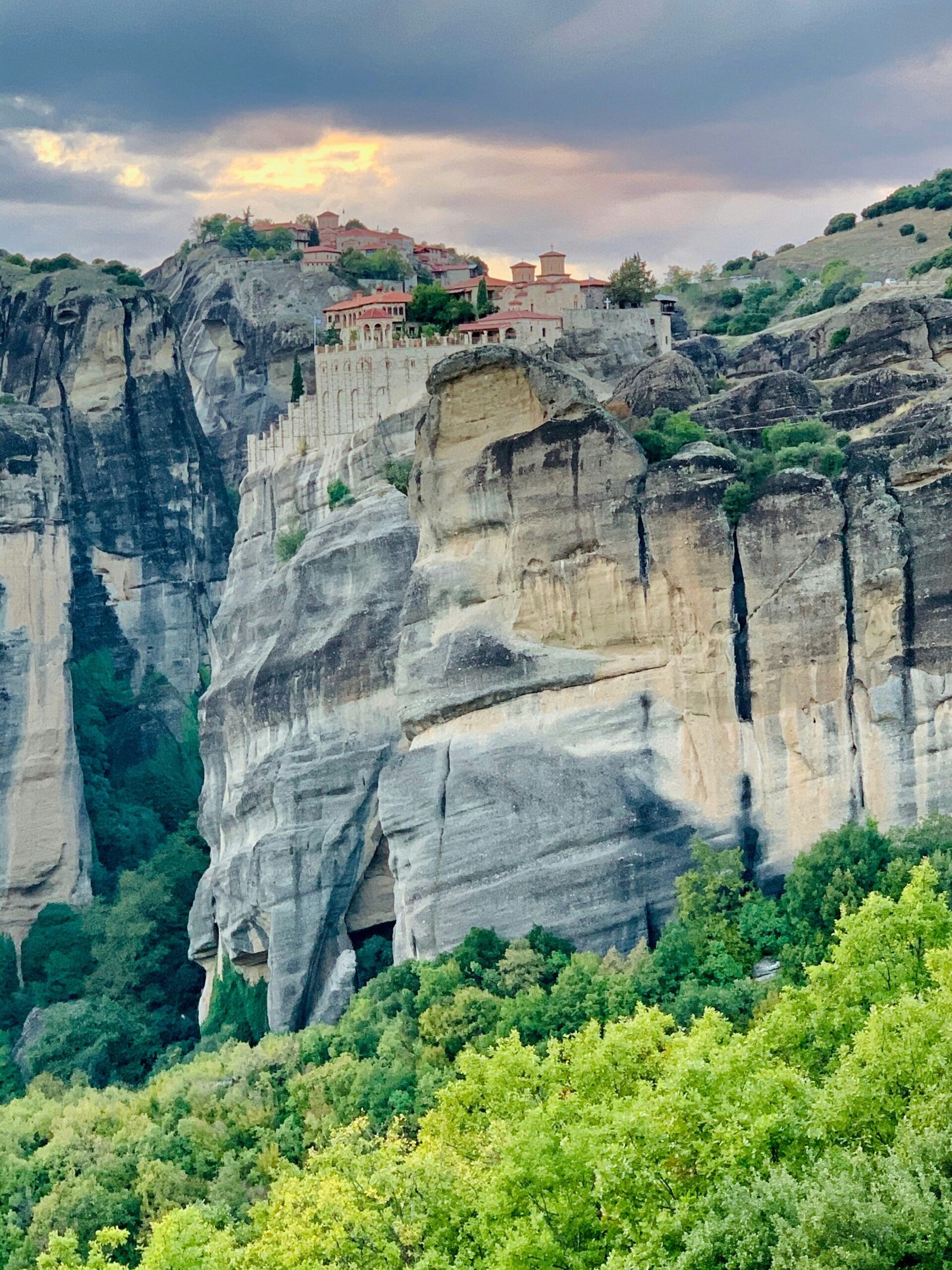 Meteora rock formations under cloudy skies, matching the contemplative mood of a winter retreat in Greece.