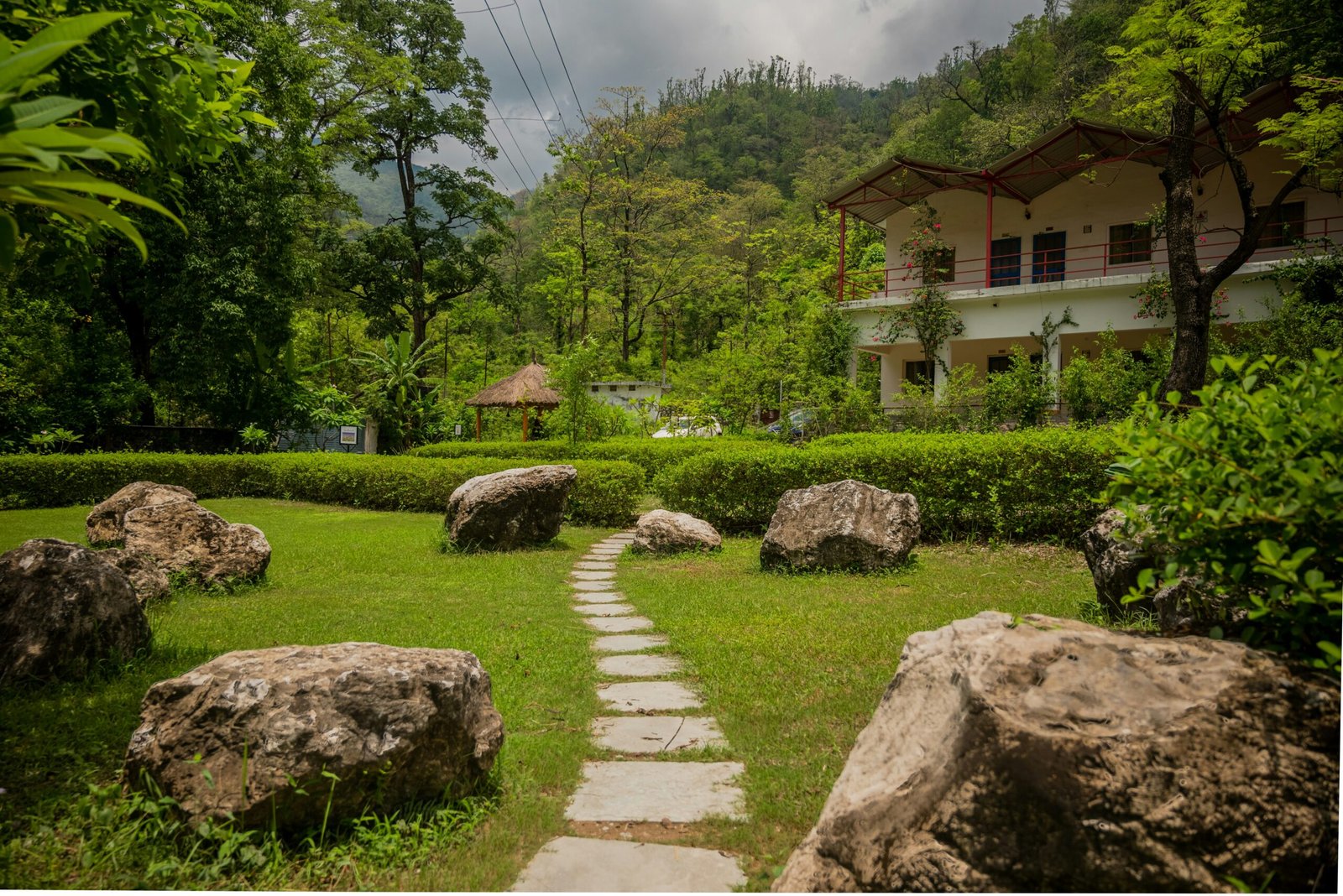 Stone pathway through a grassy landscape, matching the quiet and reflective surroundings of a retreat in nature.