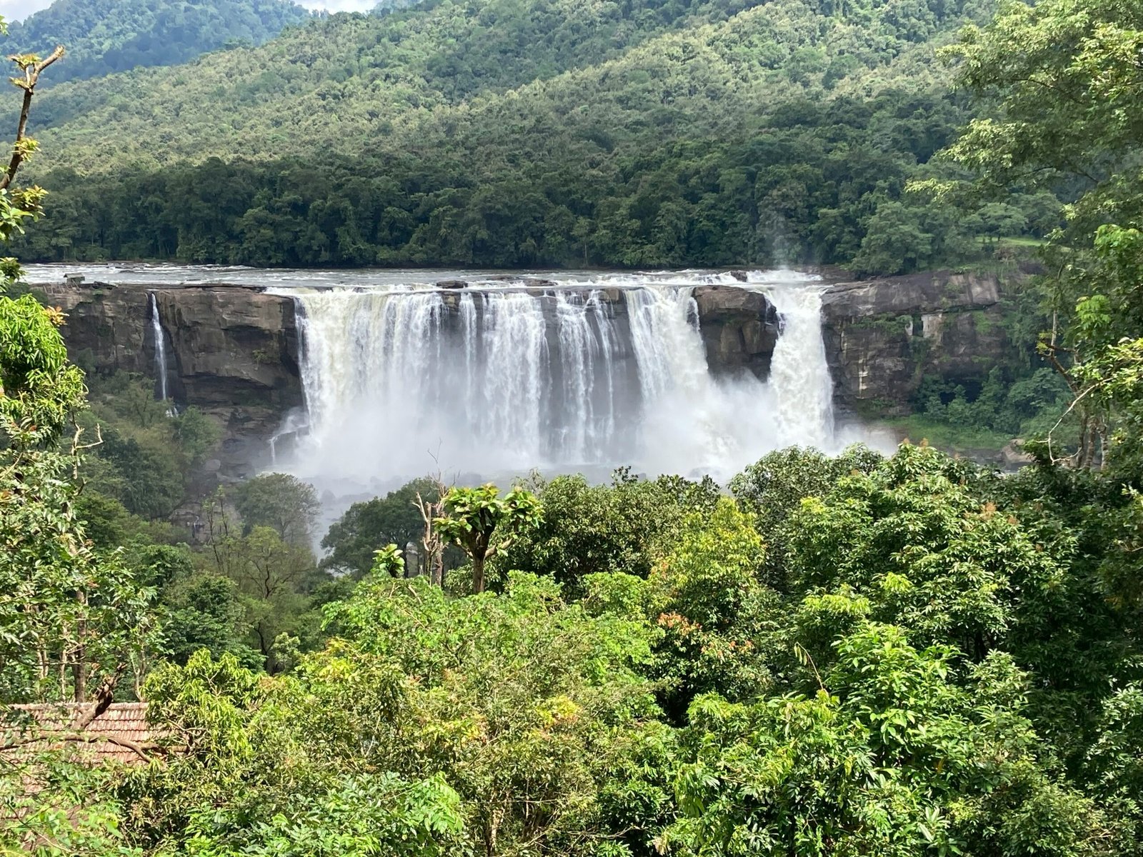 Athirappilly Falls surrounded by lush forest in Kerala, reflecting the fresh post-monsoon energy of a September healing retreat in India.