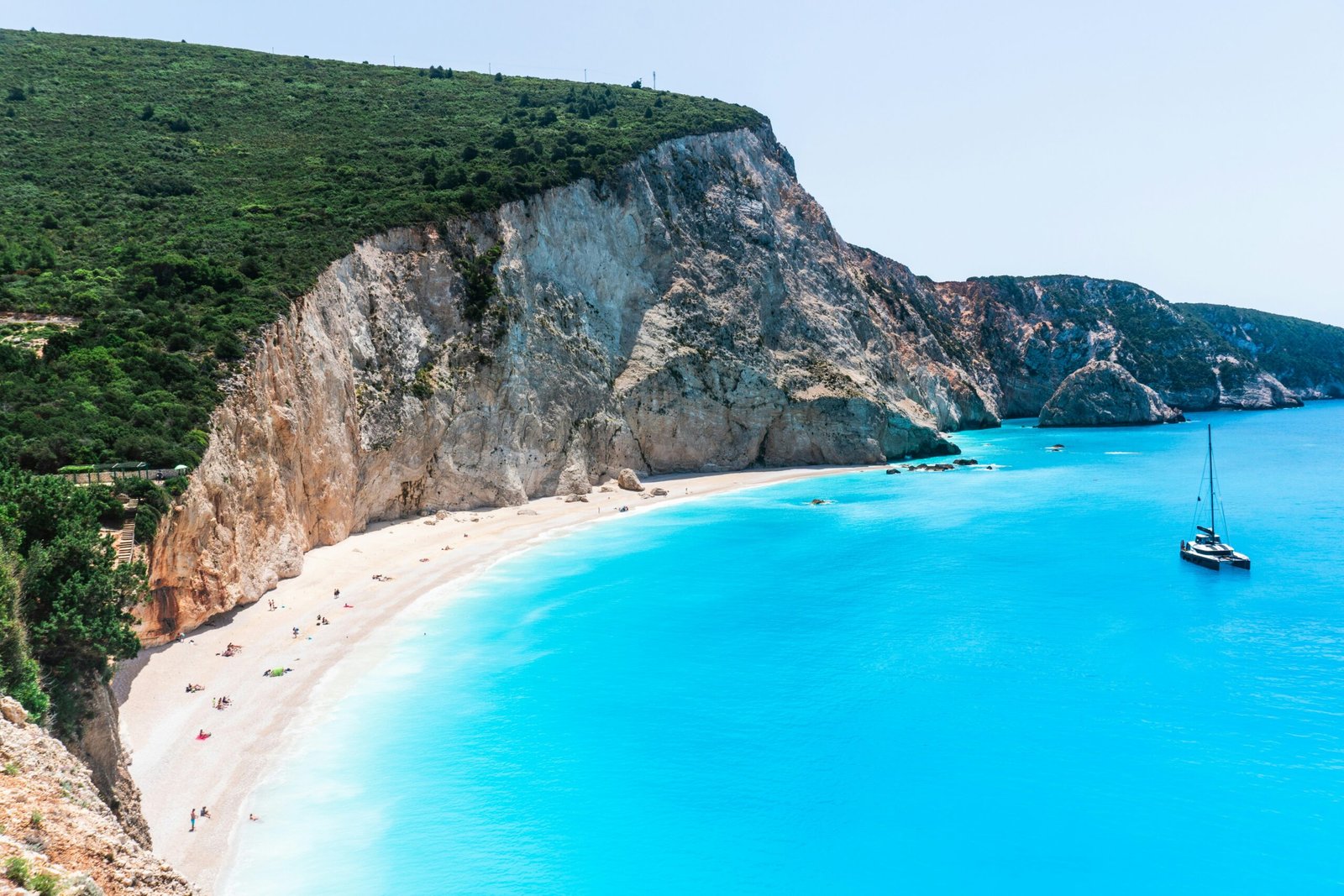 Green cliffs above the blue sea at Porto Katsiki in Lefkada, creating a wild and restorative setting for a Greece retreat.
